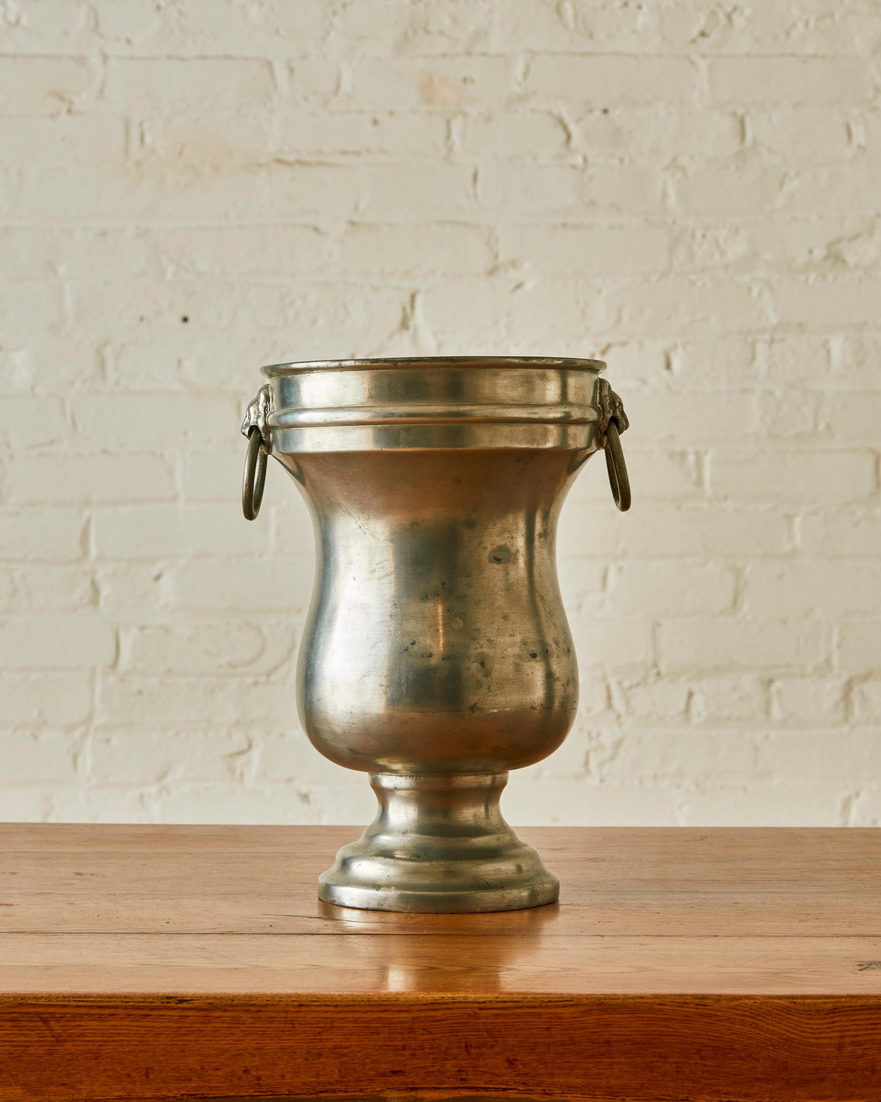 Wine Bucket by Christian Dior in pewter with a balustor form with a lion mask and ring handles. Stamped on the underside  