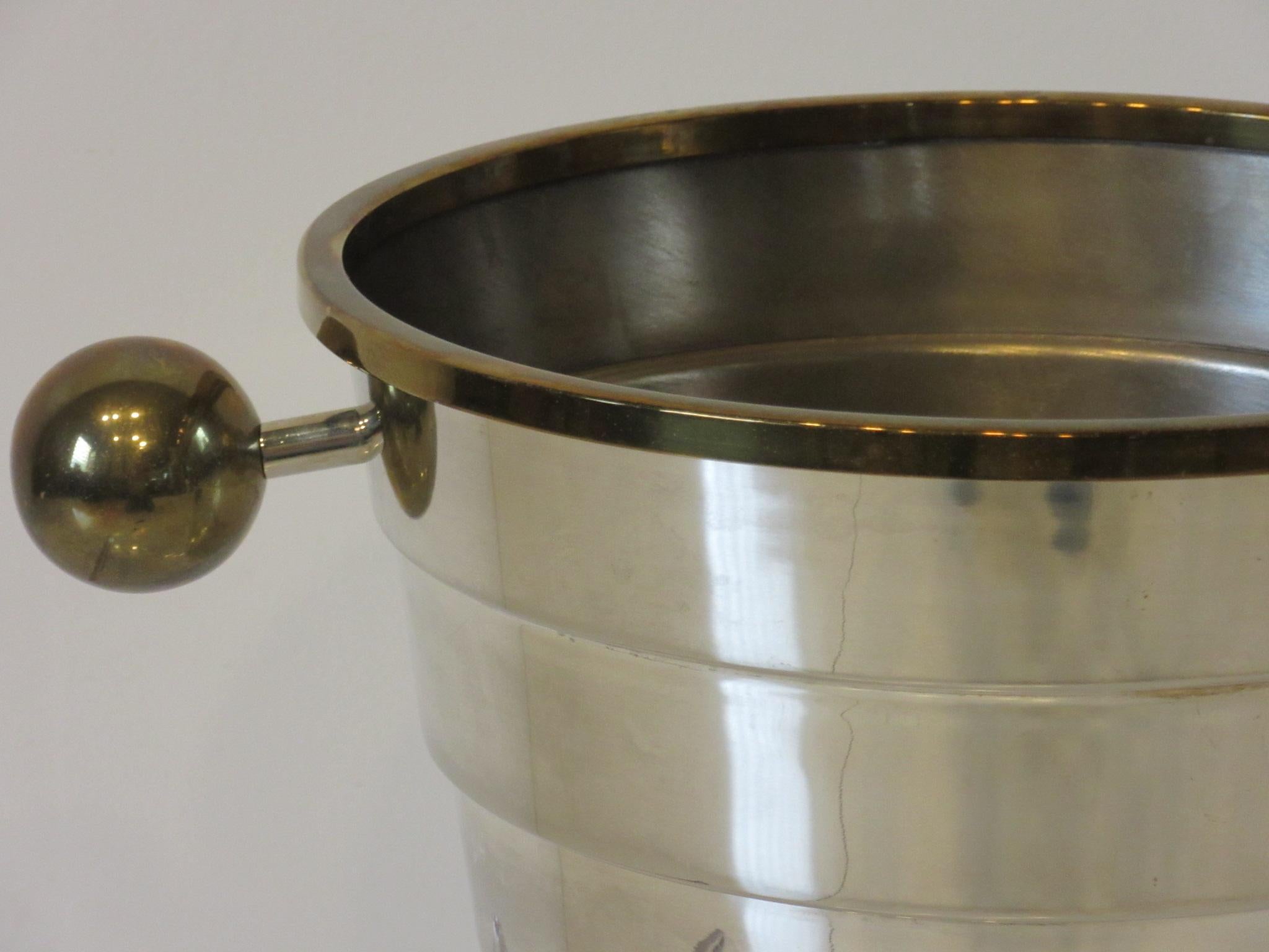 A Memphis styled silver plated wine / champagne ice bucket designed with large round brass handles and brass details by Larry Laslo for the Towle silver company. Crafted in Italy and well hallmarked to the bottom with Laslo - his hallmark - Italy -