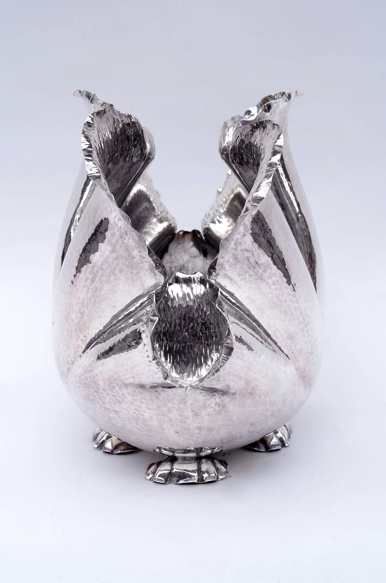 Hammered silver plated wine cooler or champagne bucket, in cabbage shape, designed by the French fashion designer Christian Dior, circa 1970.
The Christian Dior signature is visible below, between the four little legs in shell shape.