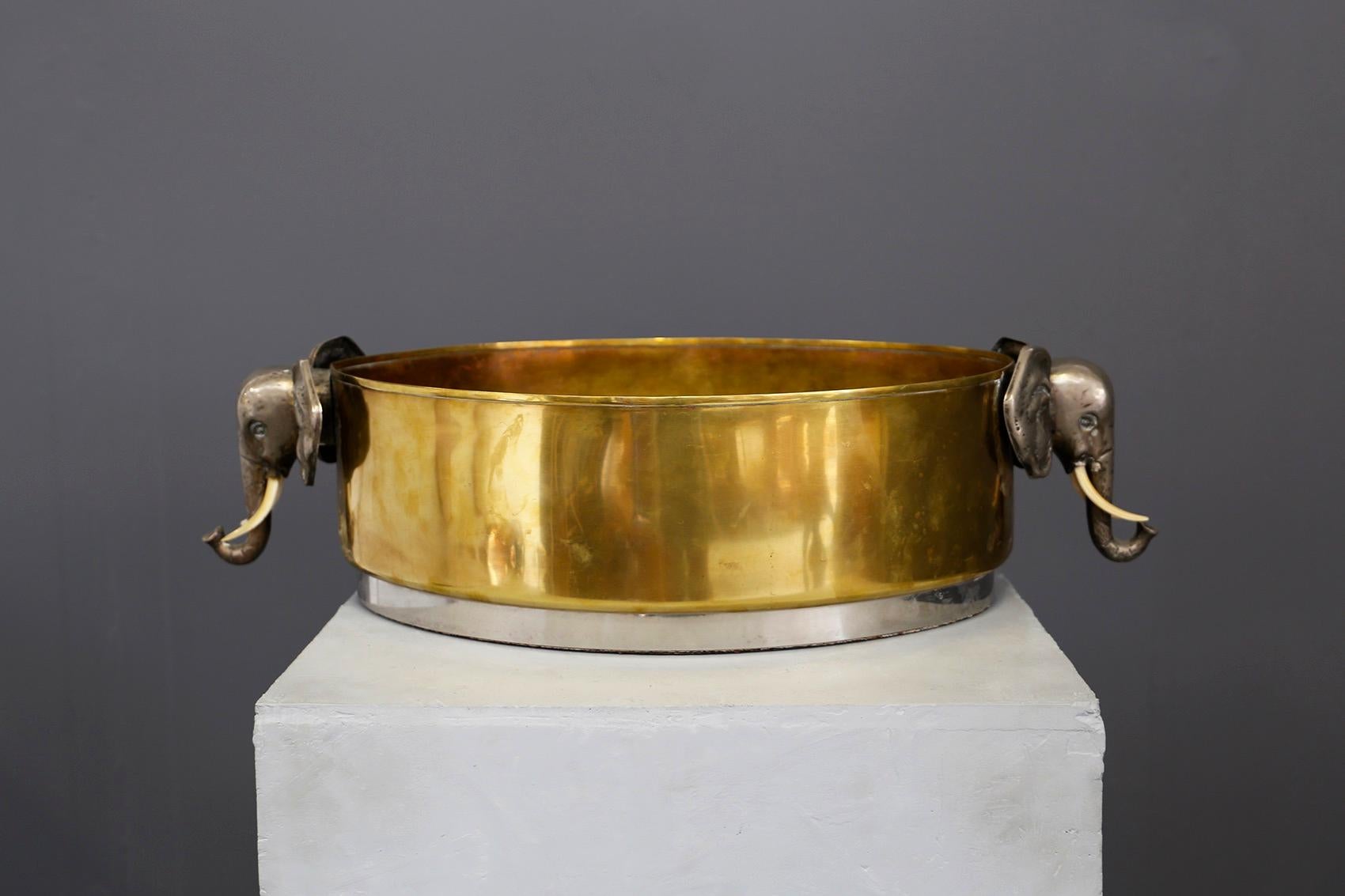 Elegant ice holder for Champagne in brass from the 1970s. The container is made of brass and chromium-plated steel. At both ends we find two figures carved in brass of two elephants. In the base we find a chromium-plated steel border. Given its