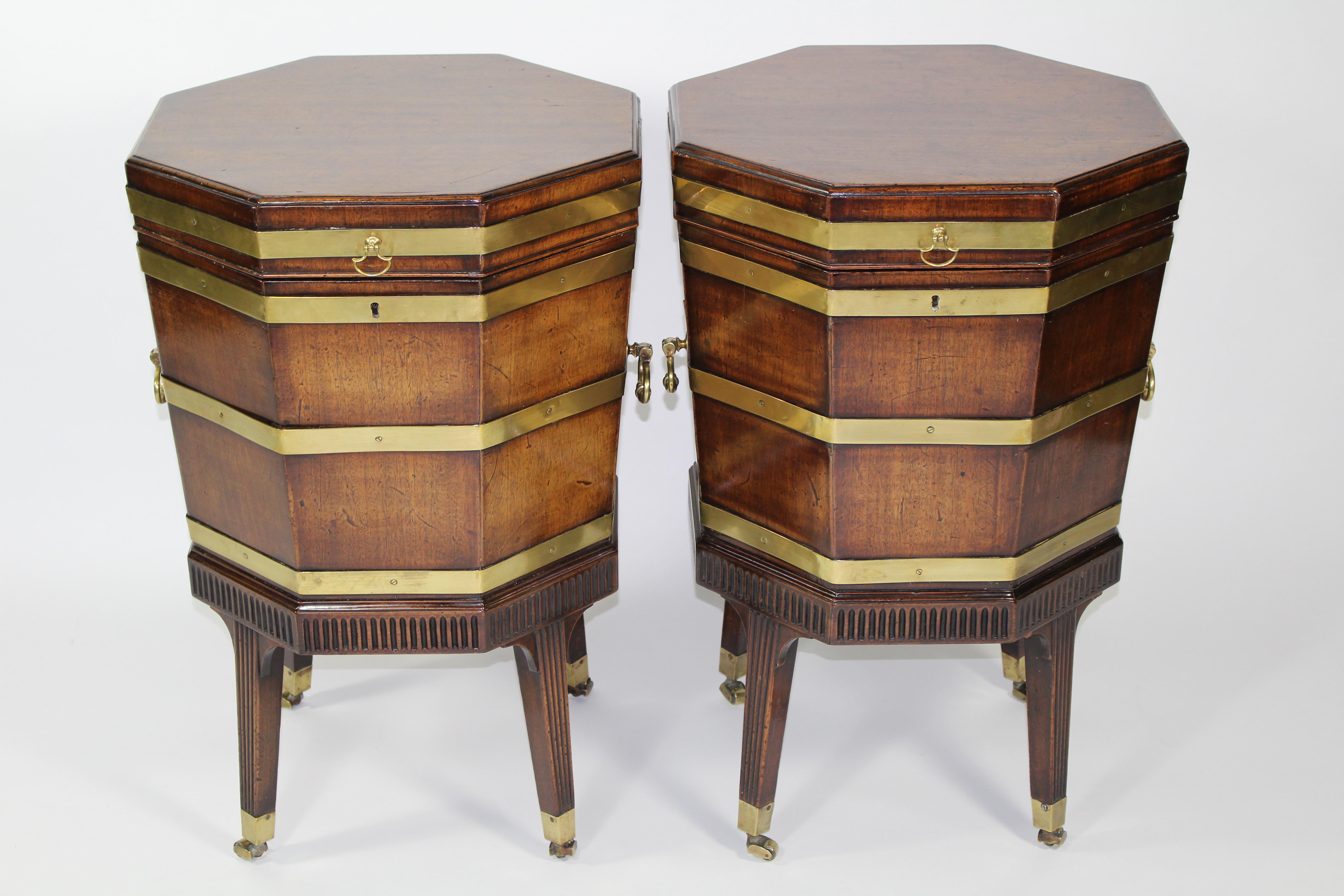 An outstanding pair of Georgian octagonal brass bound mahogany wine coolers/ cellerets also known as gardes de vin. Which are recorded in George Hepplewhite’s The Cabinet Maker and Upholstery’s 1st Edition 1788, 2nd Edition 1789 and 3rd Edition