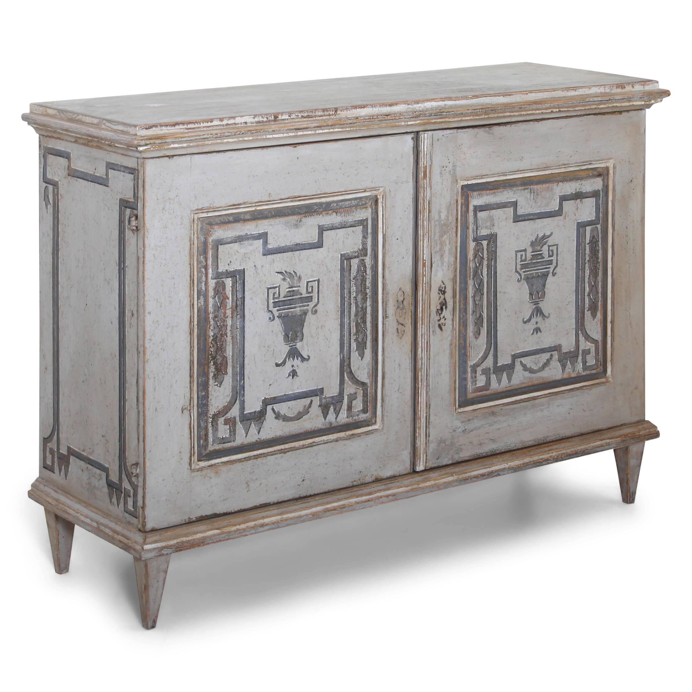 Two-doored sideboard on tapered feet. The interior shows square compartments for lots of bottles. The grey paint with dark grey ornaments on the sides and doors is new and the legs were replaced.