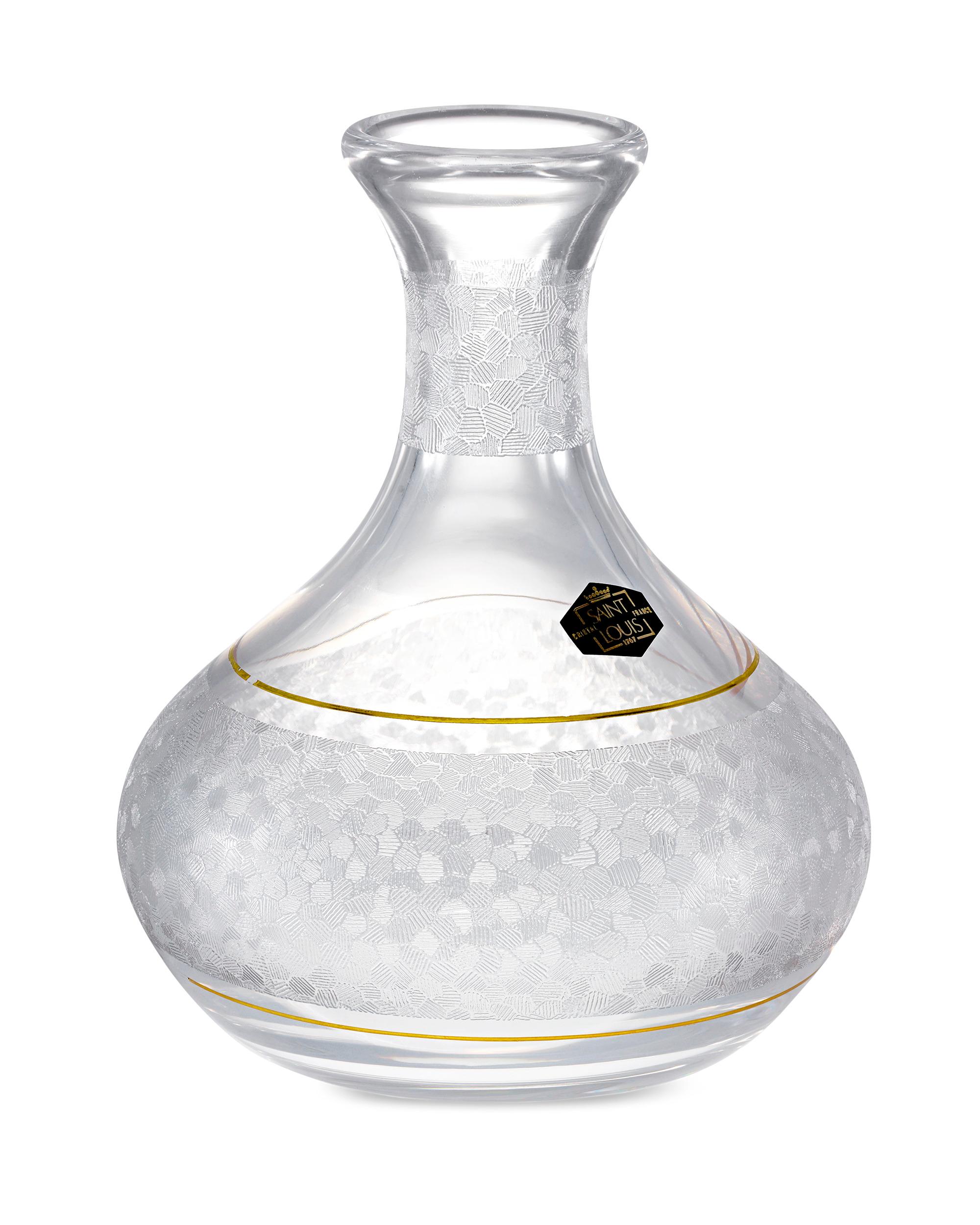 This elegant crystal wine decanter was crafted by the oldest and most respected glass manufacturer in Europe, Saint Louis crystal. Its clean, elongated form and intricate etching distinguish this beautiful piece of barware, and two bands of gilt