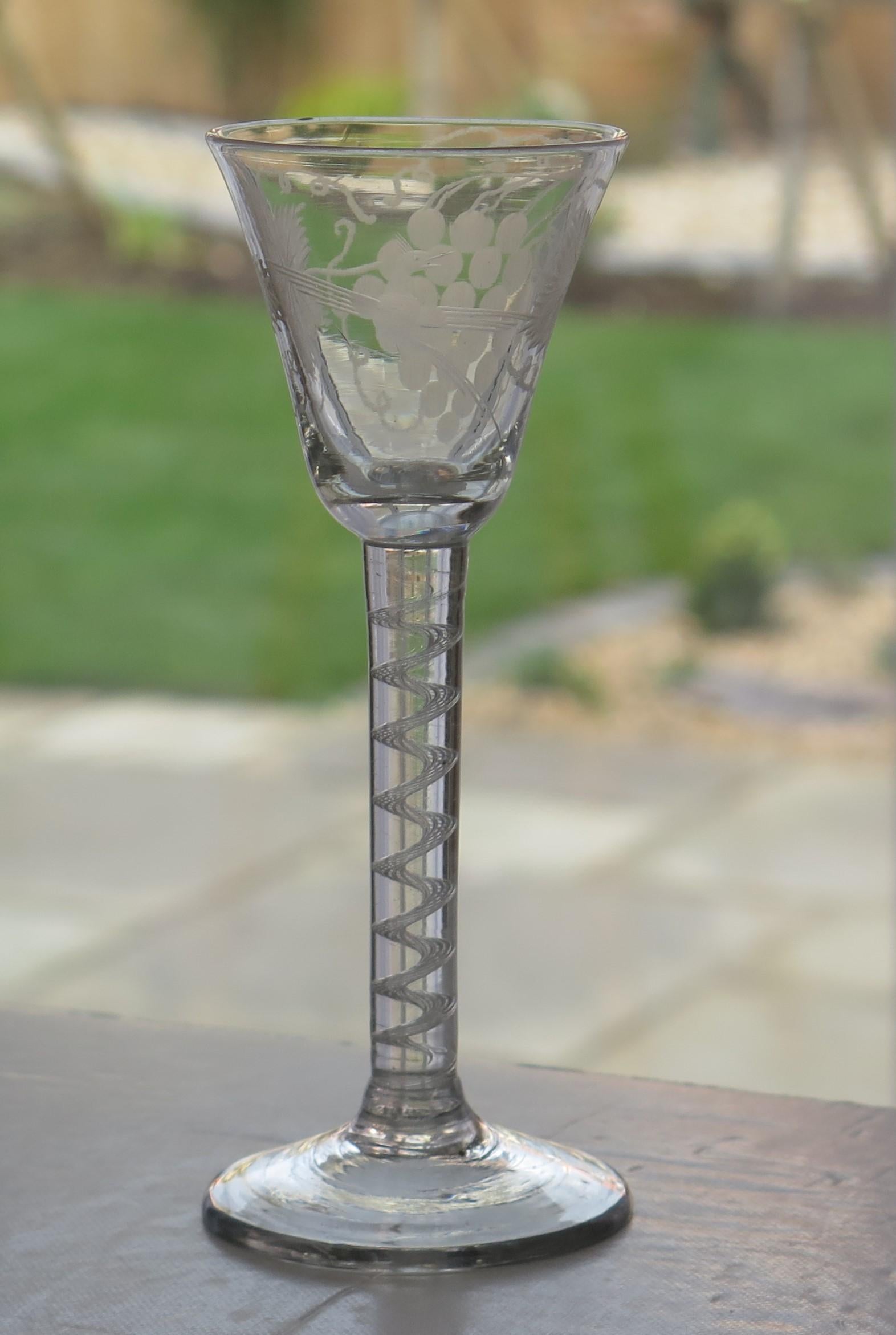 This is a very good hand-blown, English, mid-Georgian, Wine drinking glass with a round funnel (RF) engraved bowl on a single series, cotton or opaque twist (SSOT) stem, dating from the middle of the 18th century, circa 1750.

These glasses are