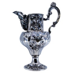 Wine jug in embossed silver with shells, scrolls and flowers