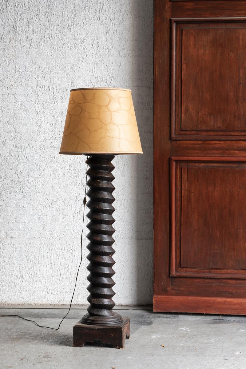 Robust floor lamp made from a wine press, produced in France during the 19th century. The antique column of this lamp was once carved out to be used as a grape press in the wine production process. These 19th century columns were later on re-used as