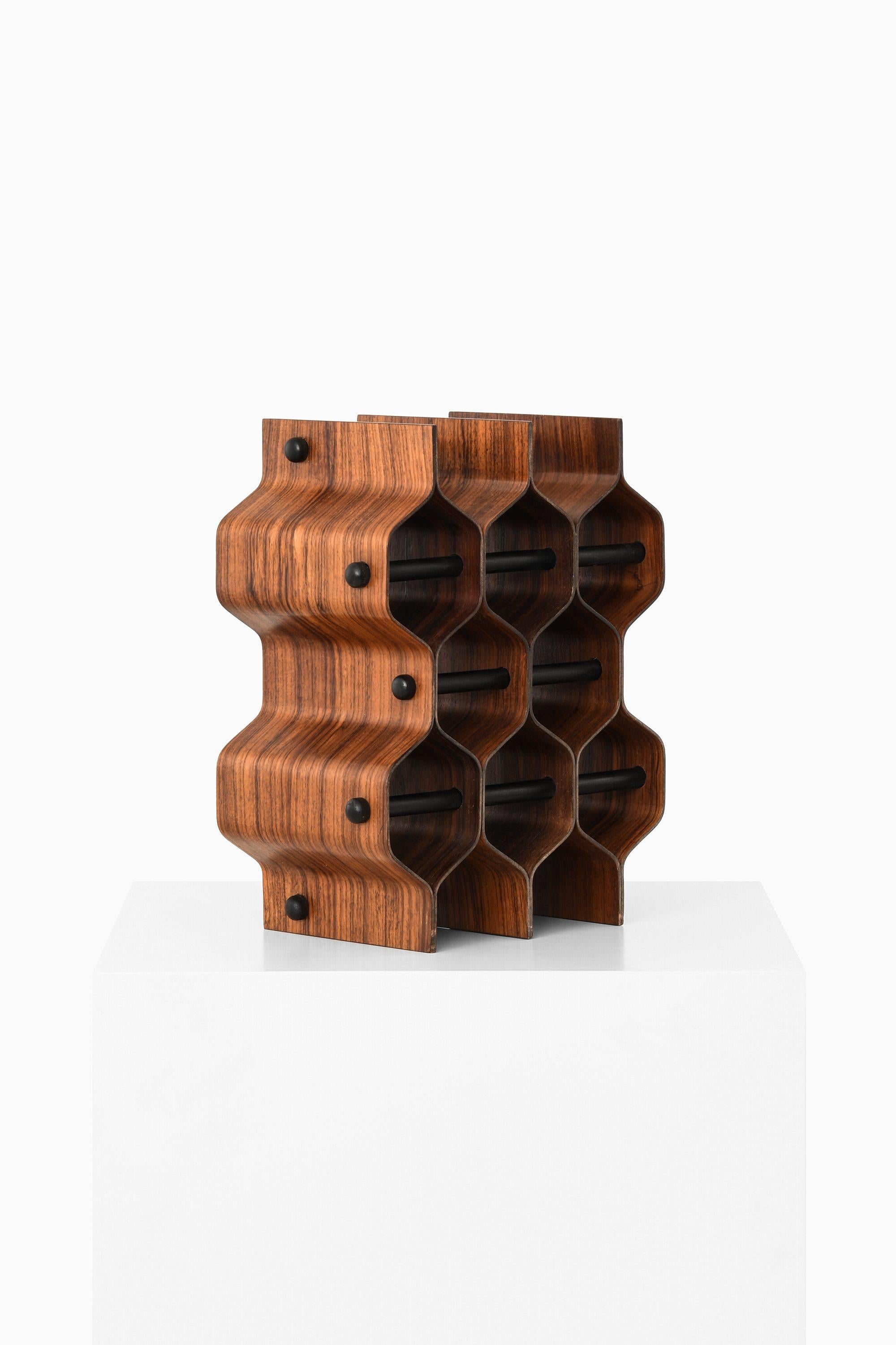Wine Rack / Bottle Stand in Rosewood by Torsten Johansson, 1950's

Additional Information:
Material: Rosewood
Style: Mid century, Scandinavian
Produced by AB Formträ in Sweden
Dimensions (W x D x H): 30.5 x 18 x 38 cm
Condition: Good vintage