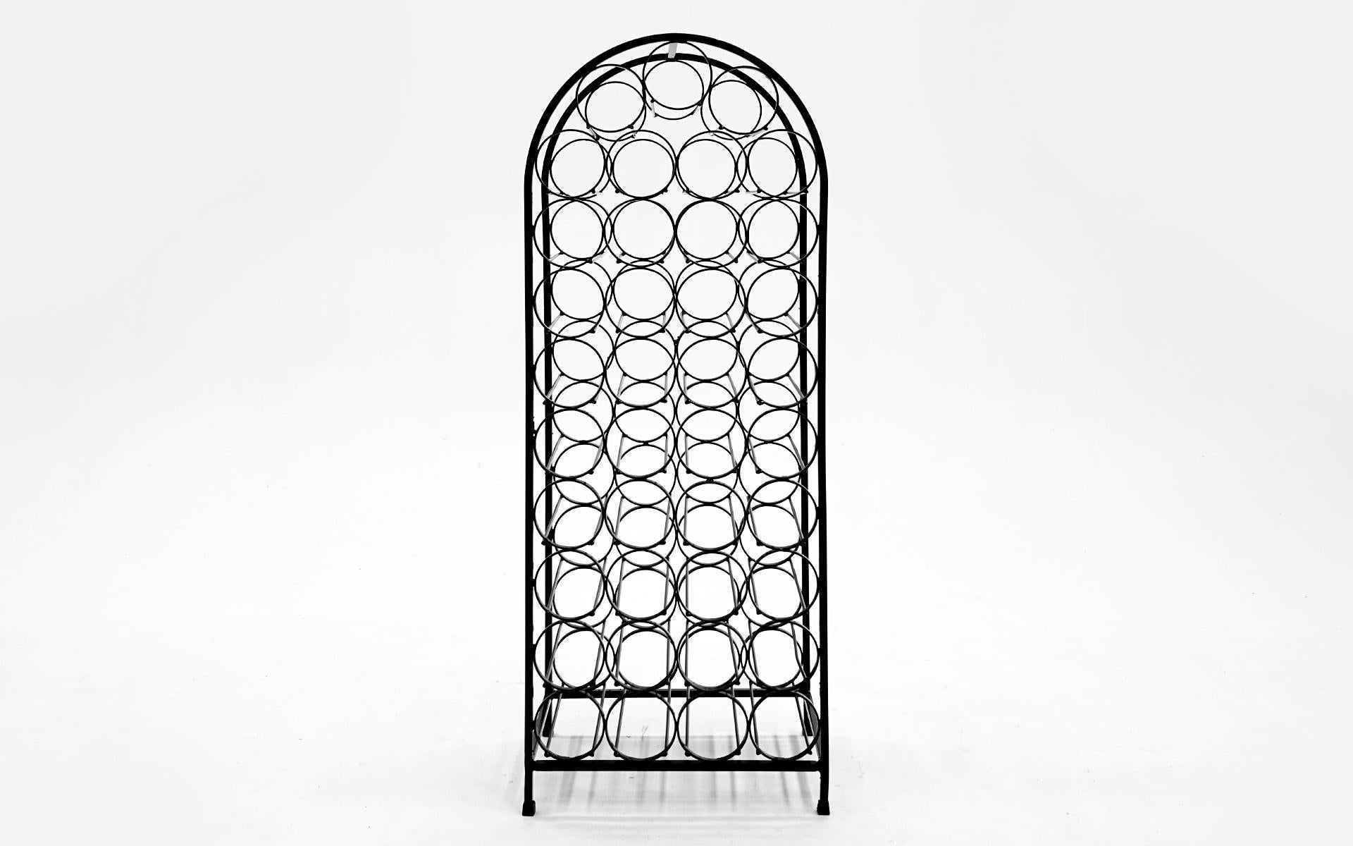 Freestanding wrought iron wine rack / holder designed by Arthur Umanoff, 1960s. Professionally restored and powder coated in a black satin finish. The only evidence of any wear are to the original rubber feet.