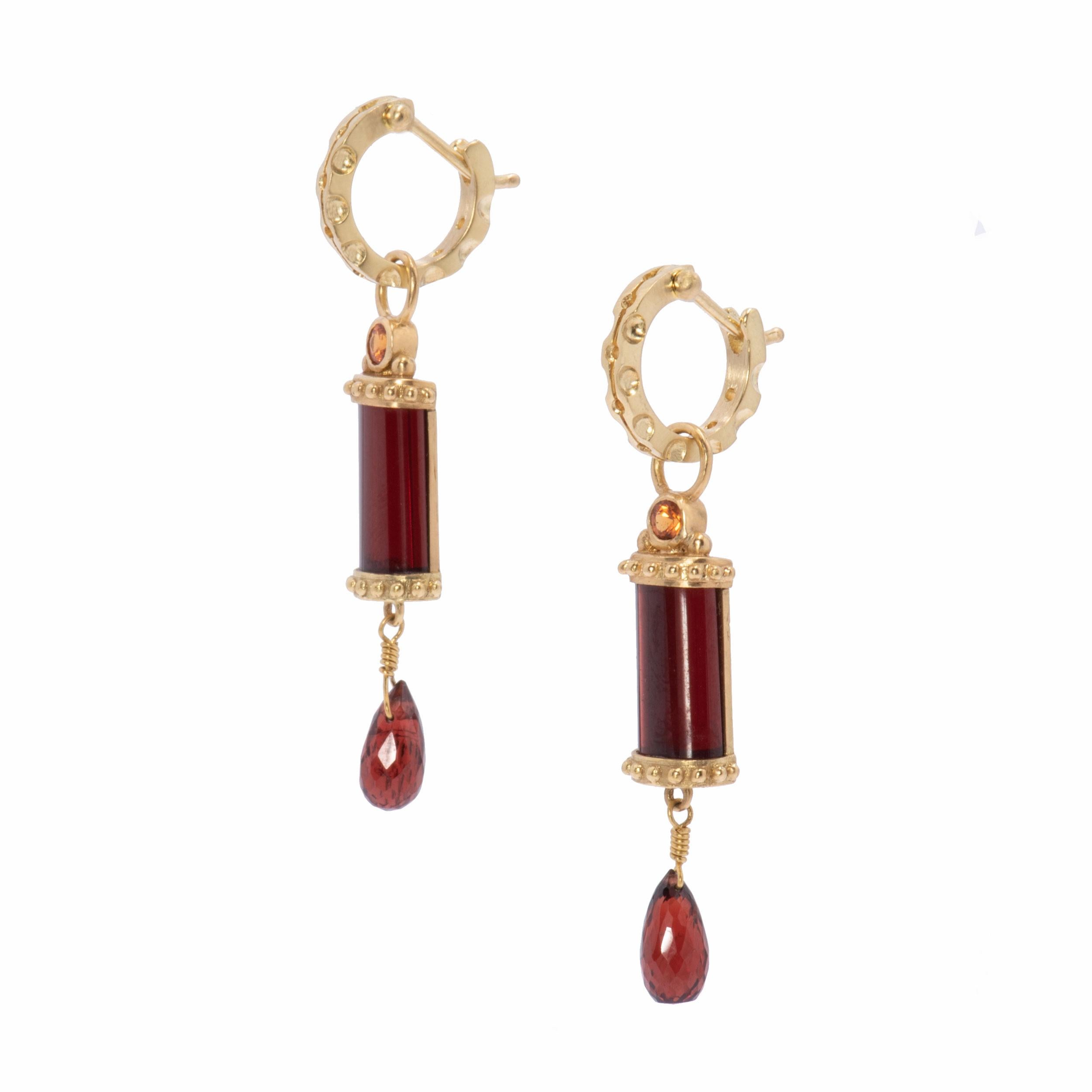 The drama of these long Wine Red Garnet Column Drop Earrings cannot be overstated. With a rounded cabochon front, wine red garnets are set in 18k gold with beaded tops and bases, and backed the length in 18k gold. Pumpkin colored spessartine garnets