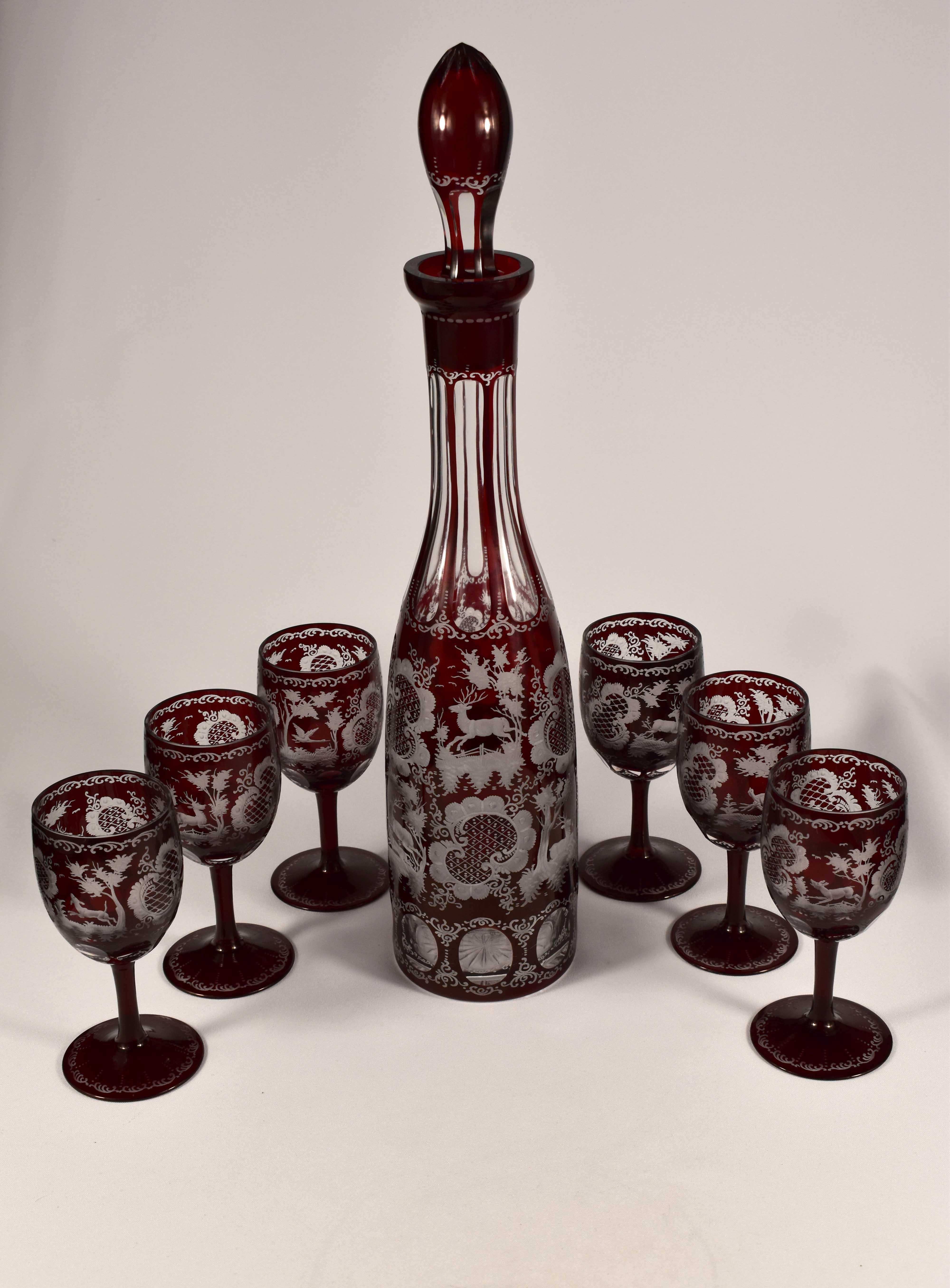 Magnifique ensemble à vin avec carafe. Travail étonnant des verriers tchèques. C'est un verre clair avec une glaçure rubis. La carafe et les gobelets sont taillés, ils sont gravés d'un décor Egermann typique 19-20ème siècle, il s'agit d'une gravure