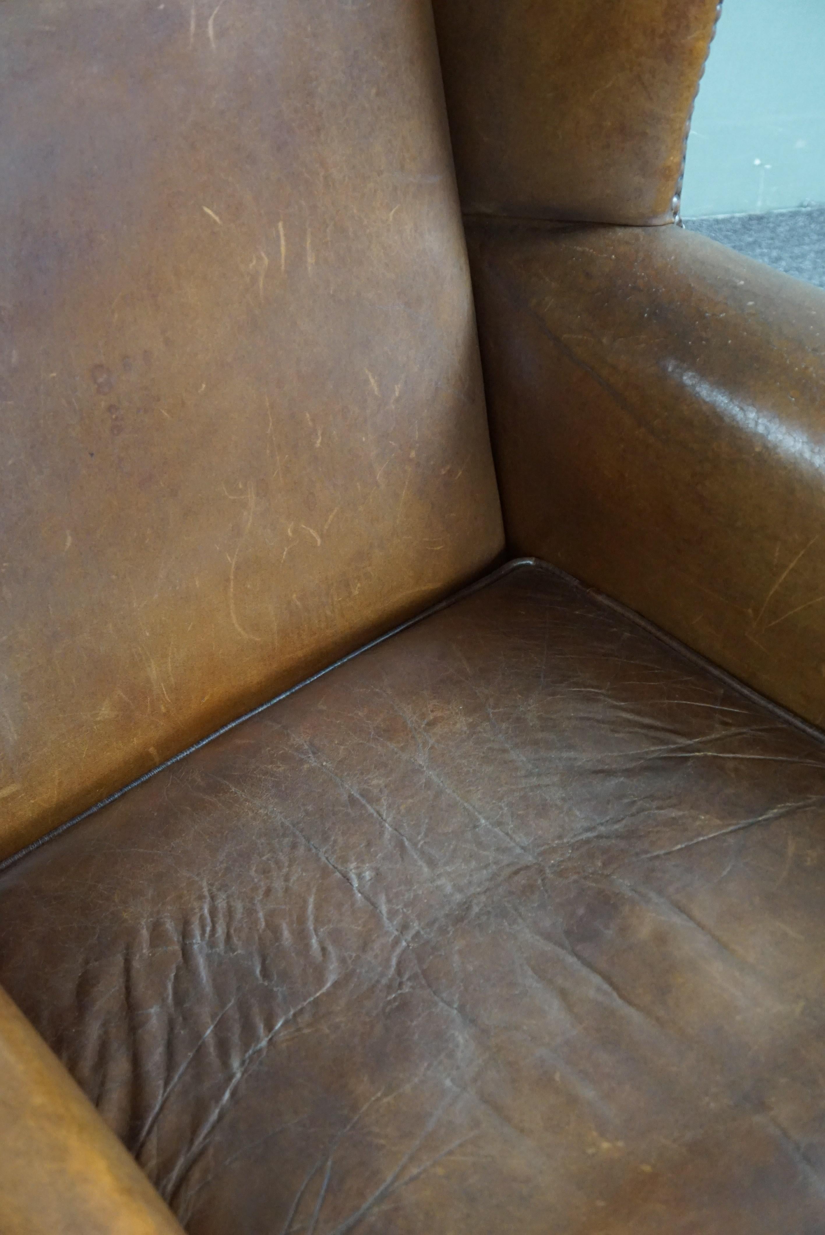 Wing armchair full of character, made of sheep leather For Sale 4
