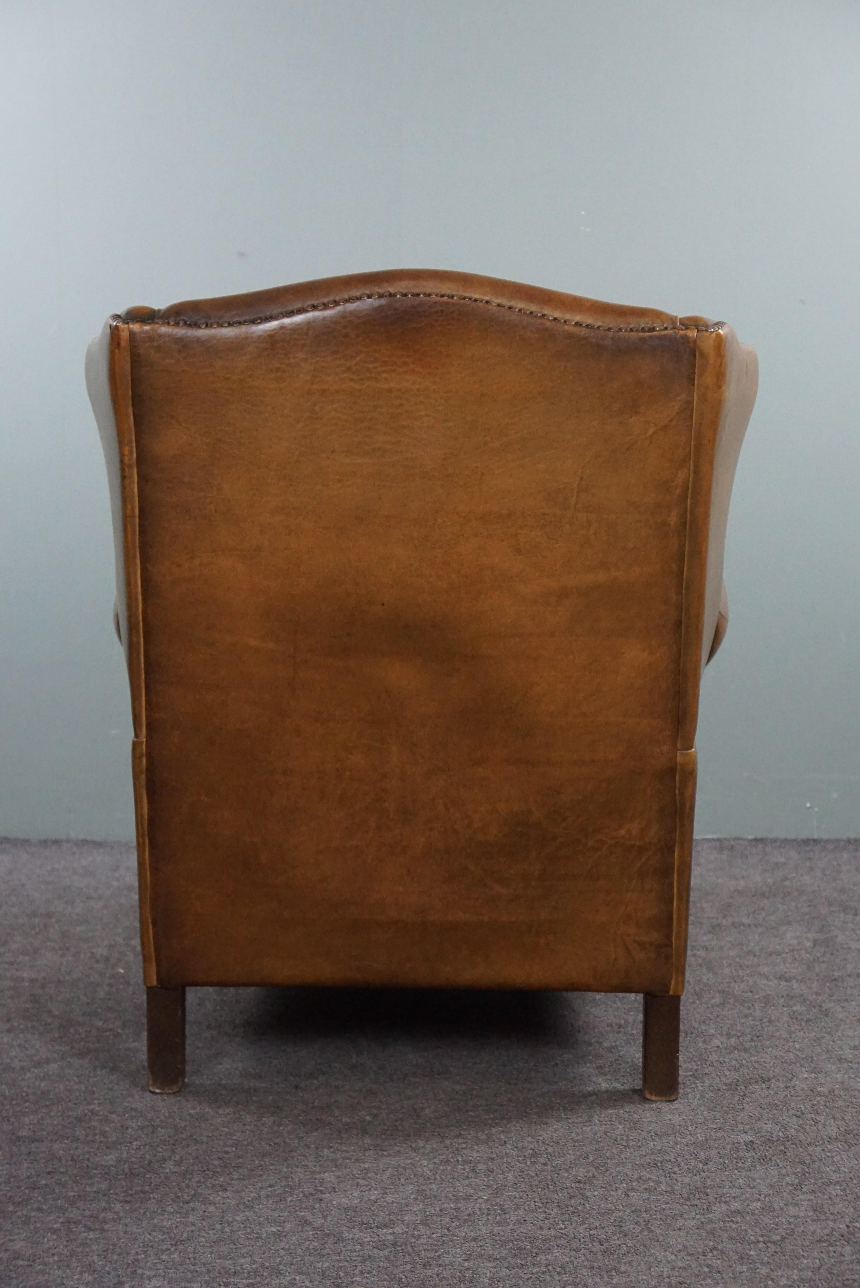 Hand-Crafted Wing armchair full of character, made of sheep leather For Sale