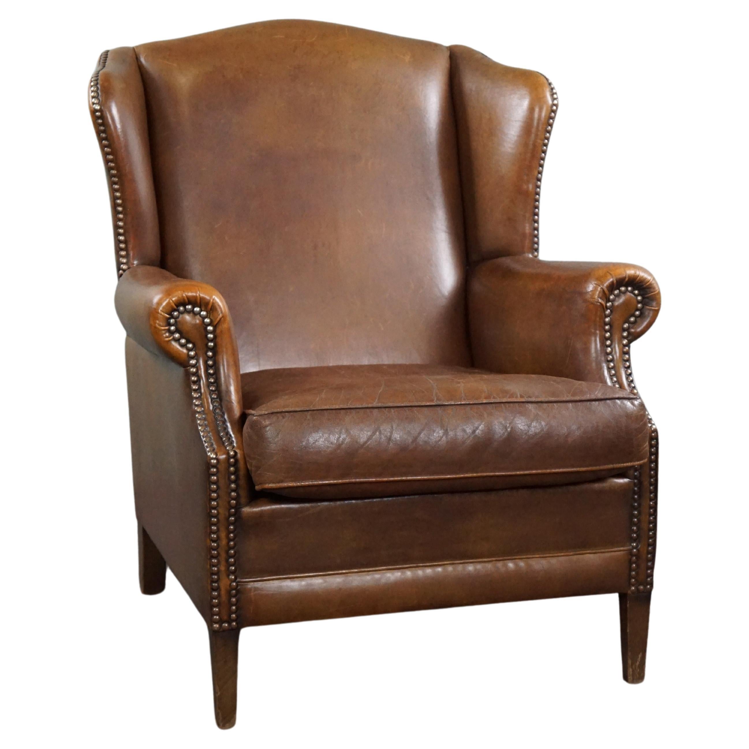 Wing armchair full of character, made of sheep leather For Sale