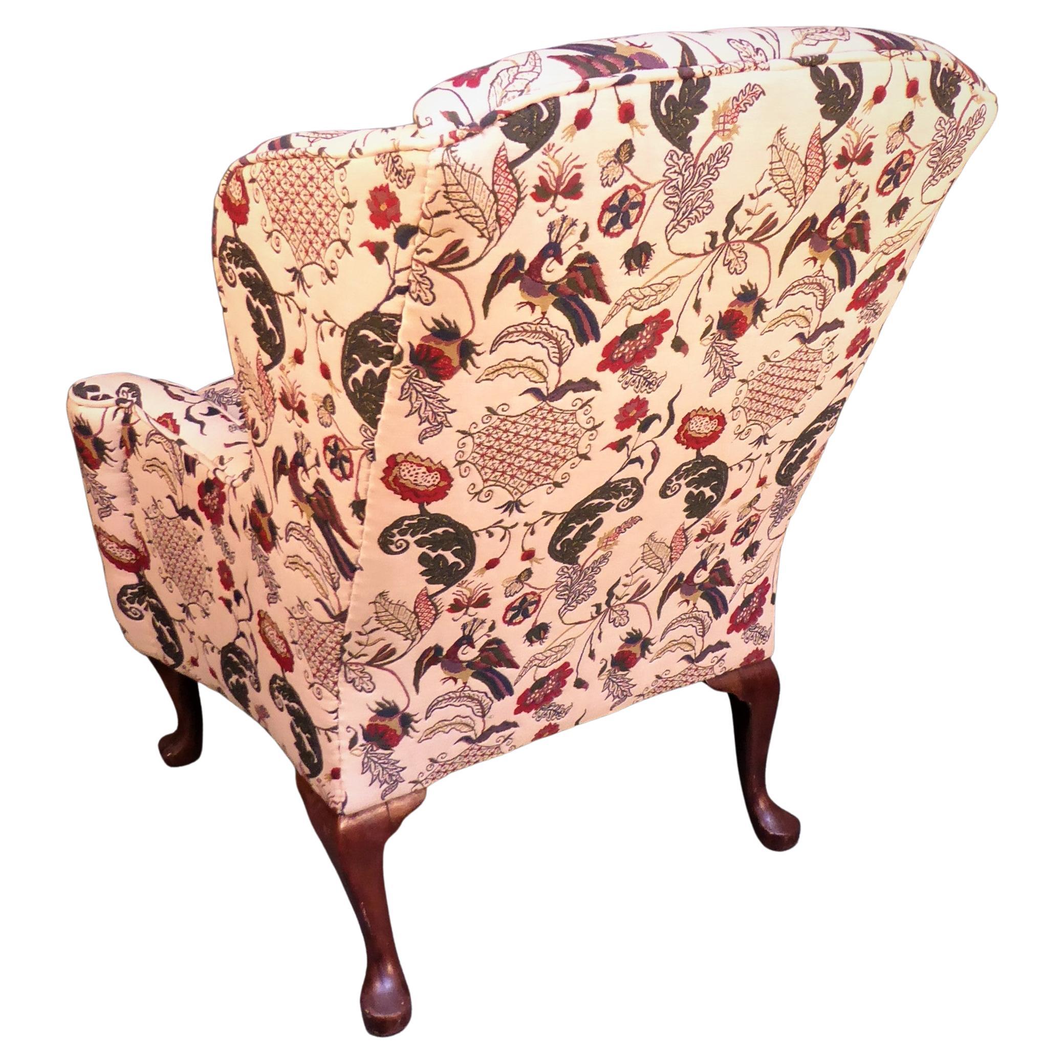 Wing chair with strongly shaped wings and arms, raised upon cabriole legs with beautifully carved shell motif at the knee, and carved slipper feet. This chair has been covered in a fabulous wool and cotton material called 'English Needlework'  - A