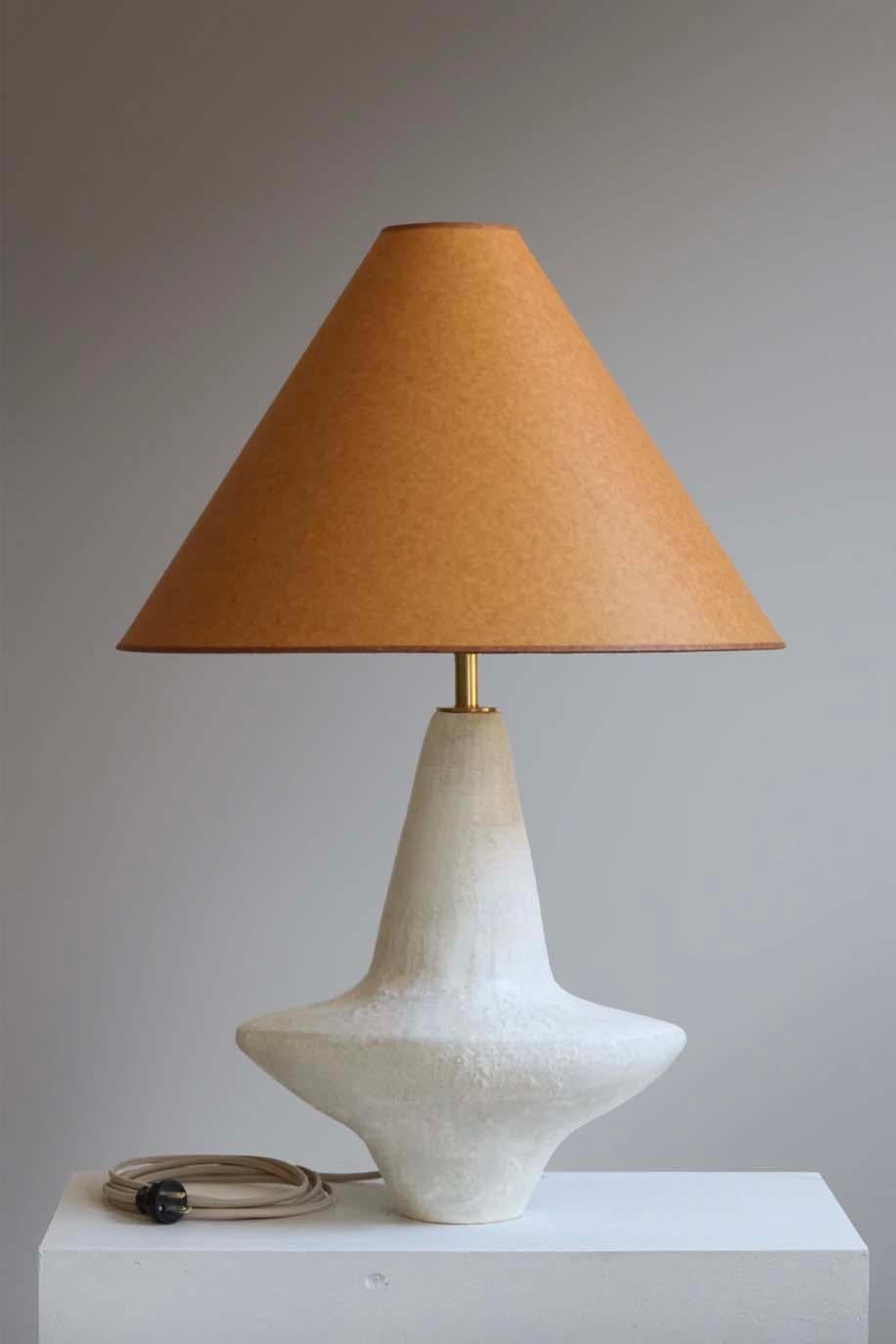 The Wing lamp is handmade studio pottery by ceramic artist by Danny Kaplan. Shade included. Please note exact dimensions may vary.

Born in New York City and raised in Aix-en-Provence, France, Danny Kaplan’s passion for ceramics was shaped by