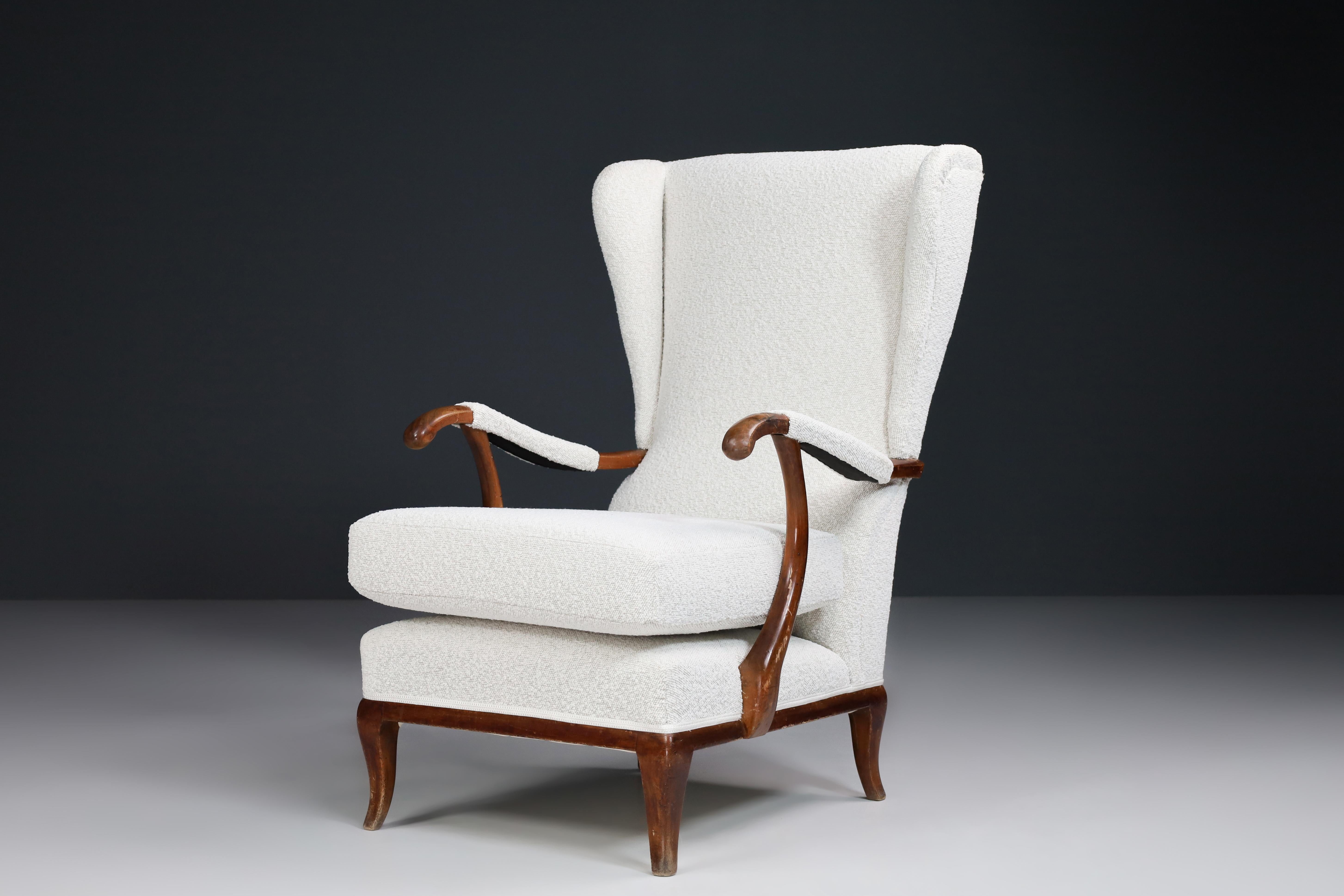 Wingback Armchair by Paolo Buffa Reupholstered in Bouclé Fabric, Italy 1940s

This elegant high-back Paolo Buffa armchair featured a sculpted wingback and armrest was made in Italy in the 1940s. This armchair has just been reupholstered with Bouclé
