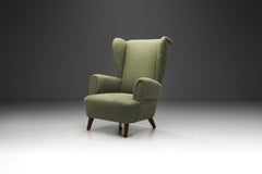 Wingback Armchair Upholstered in Dark Green, Europe Mid-20th Century