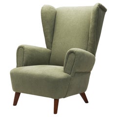 Wingback Armchair Upholstered in Dark Green, Europe Mid-20th Century