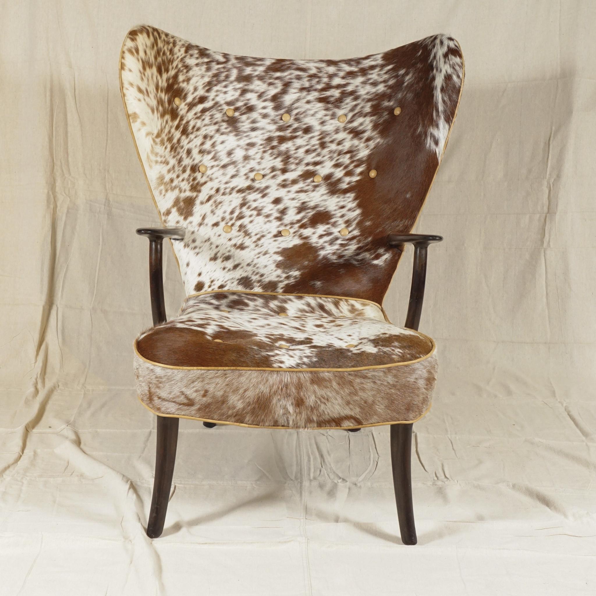 The Pragh chair, a distinctive wingback chair, by Madsen & Schubell, a Danish firm established in 1944 in Copenhagen. Newly recovered in a handsomely patterned soft cowhide, this iconic chair designed by Madsen & Schubell from 1950s is a standout.