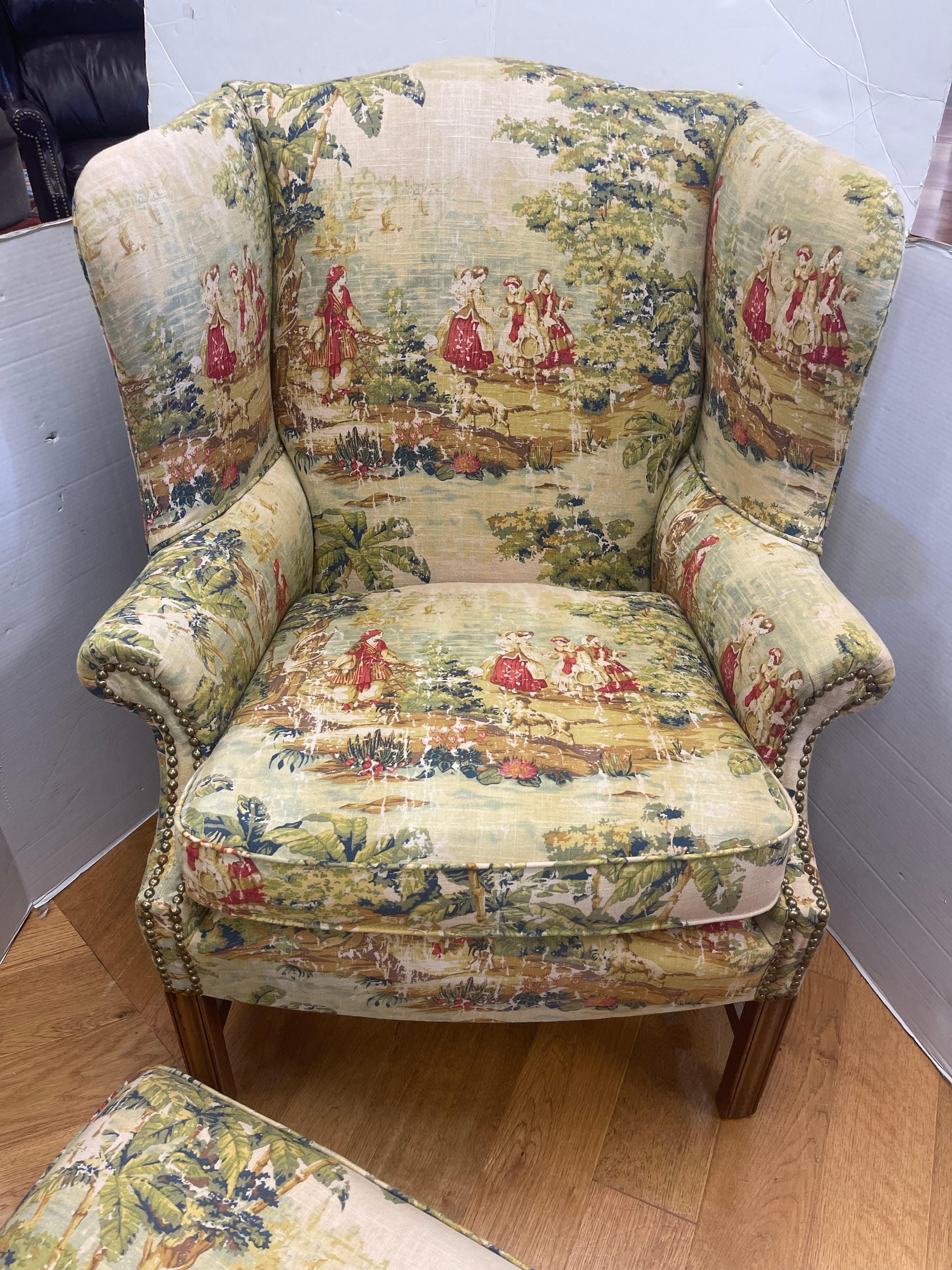 Stunning wingback chair and matching ottoman with new French toile upholstery and nailheads throughout. The piece sits exceptionally and the fabric is sublime. Excellent condition. Why not own the best?