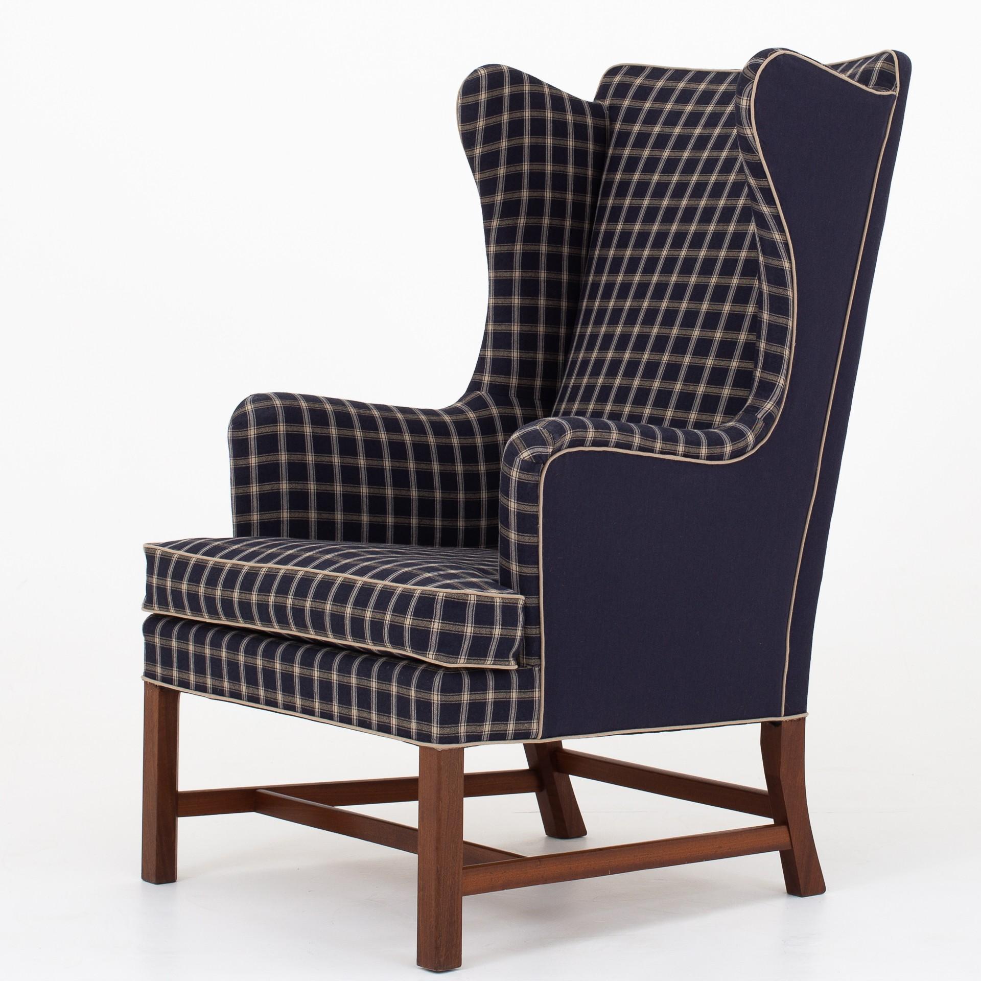 6212 - Wing back chair and stool in mahogany with new Cotil fabric. Designed in 1941. Maker Rud. Rasmussen.