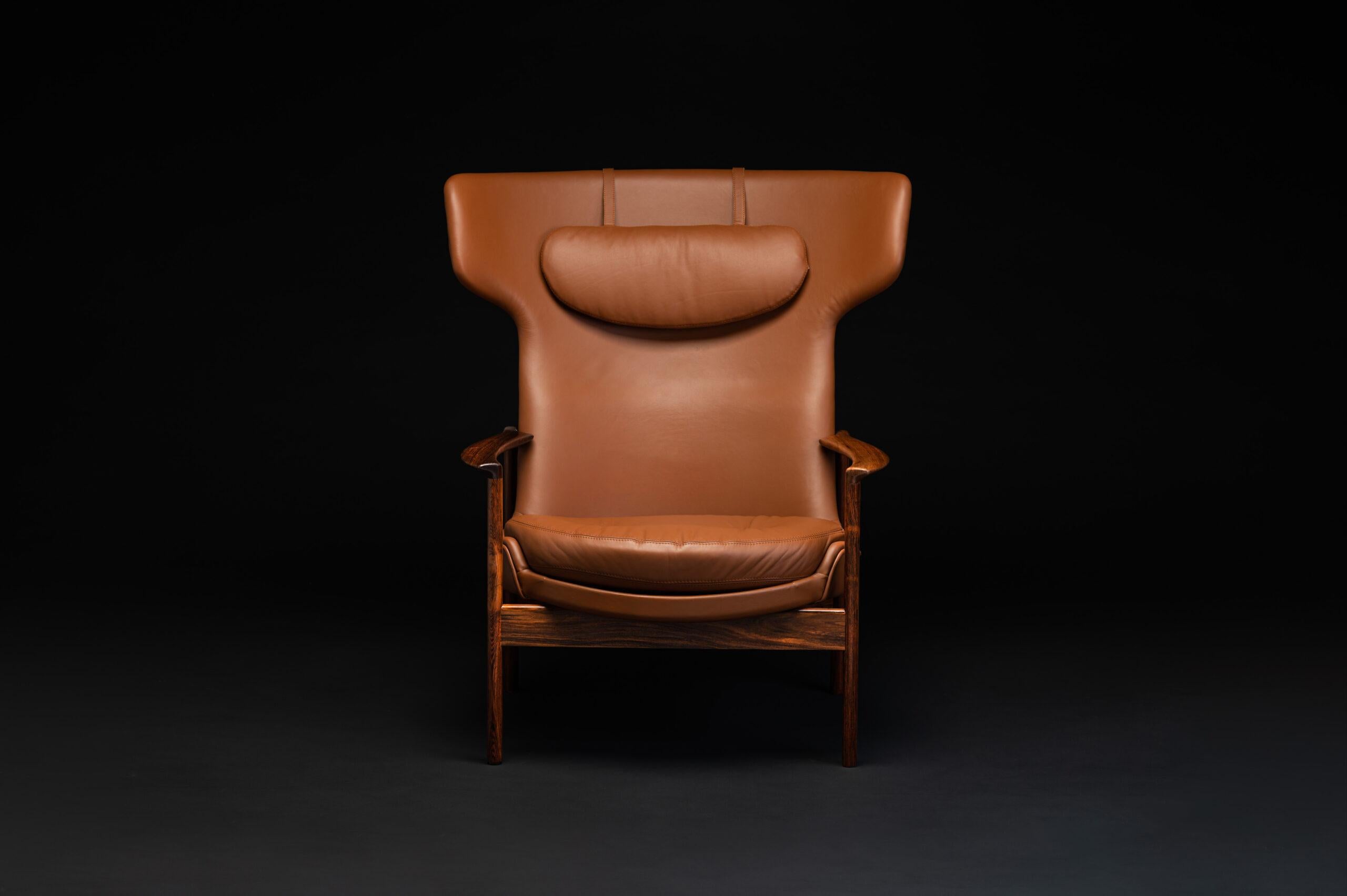 Wingback lounge chair designed by Ib Kofod Larsen in 1974 for Fröscher KG in Germany. The rosewood frame is beautifully detailed and fully restored. The leather and filling have been completely renewed in high-quality cognac brown semi-aniline