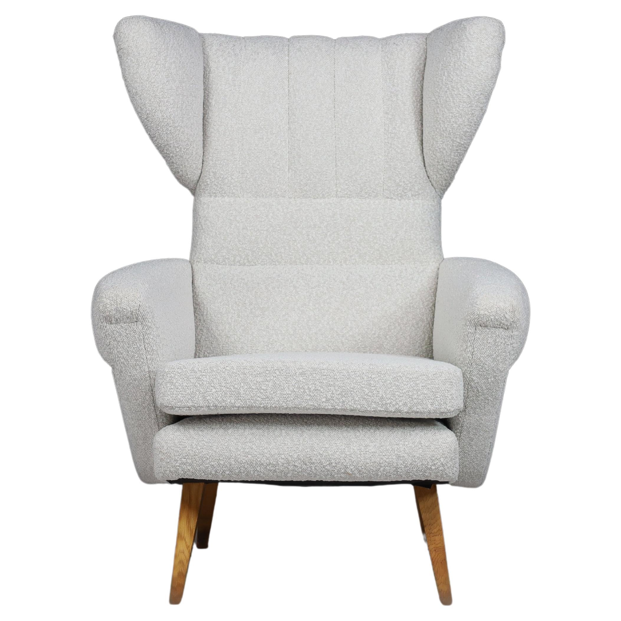 Wing Back Lounge chair in Reupholstered Bouclé Fabric, Praque 1950s

Large midcentury wingback armchair in re-upholstered bouclé fabric, Czech republic 1950s. This armchair would be an eye-catching addition to any interior, such as a living room,
