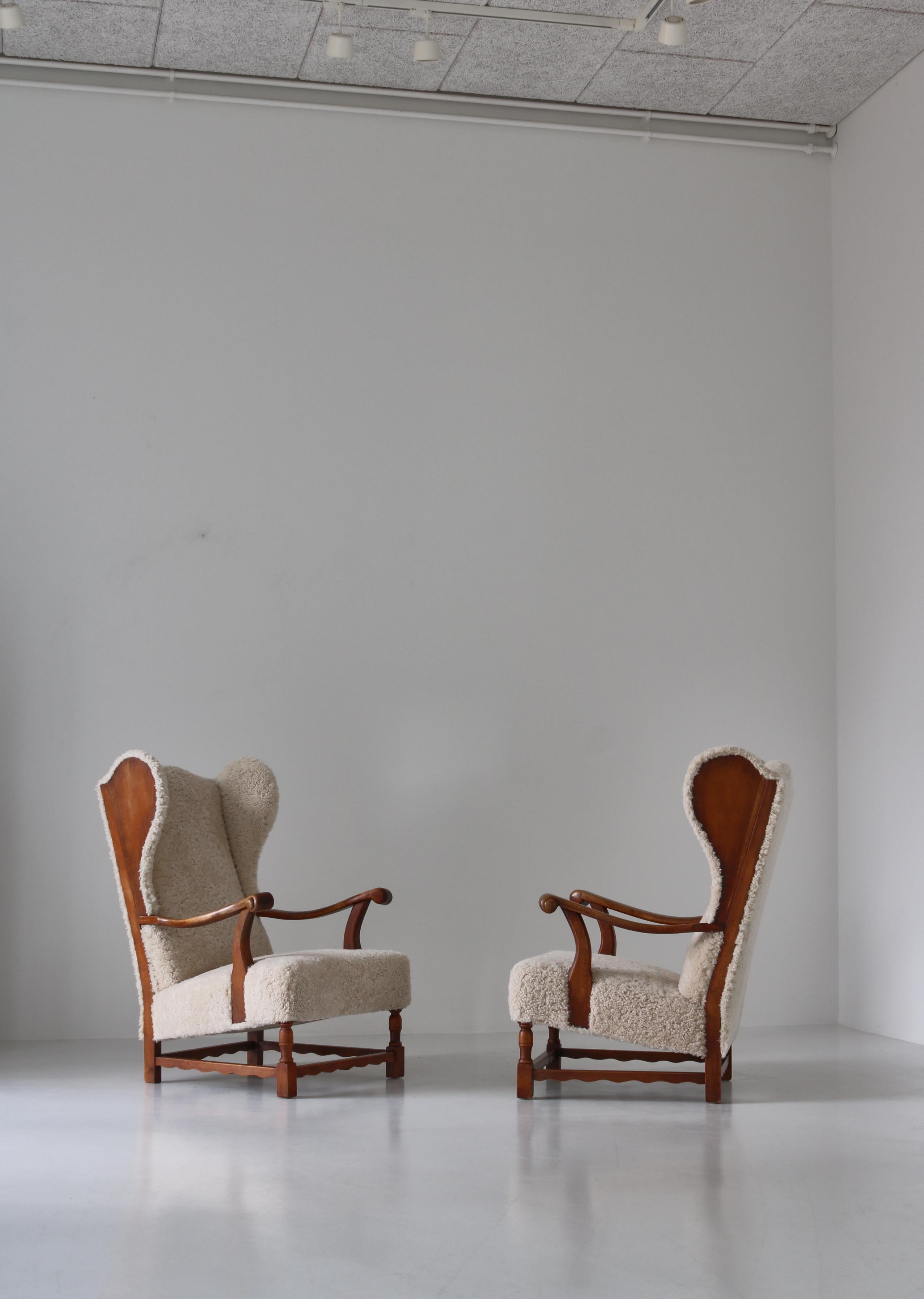 Scandinavian Modern Wingback Lounge Chairs in Solid Oak and Sheepskin by Danish Cabinetmaker, 1940s