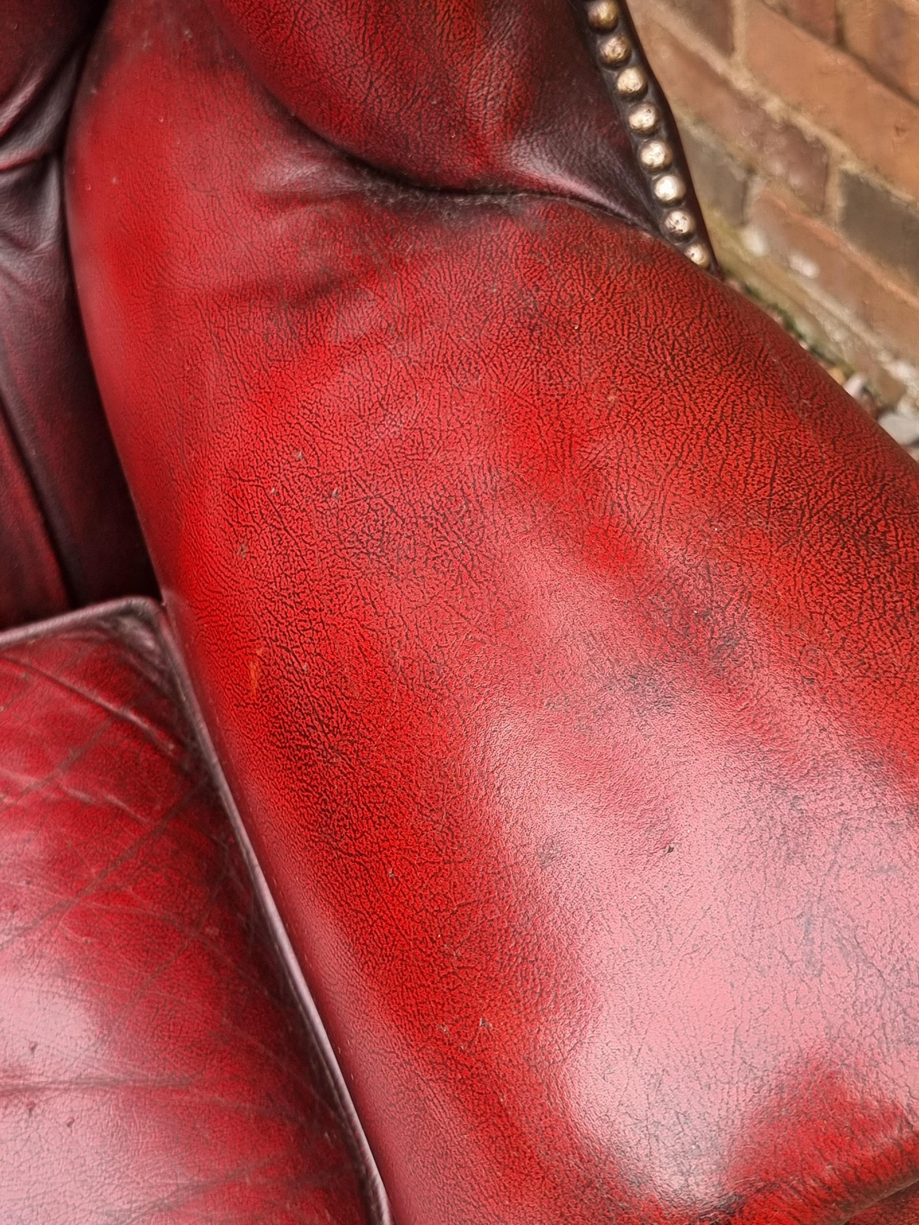 Winged armchair upholstered in deep buttoned red leather, English 1930 For Sale 11