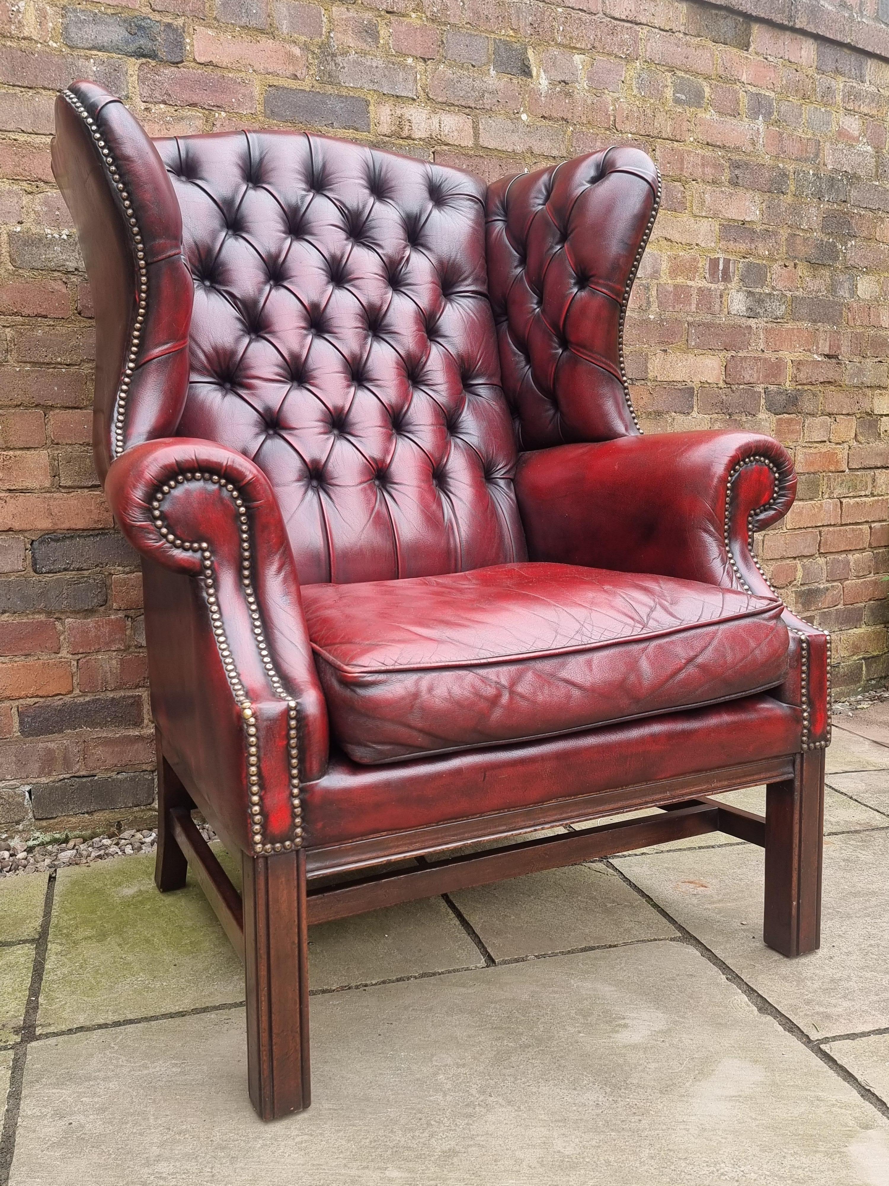George III Winged armchair upholstered in deep buttoned red leather, English 1930 For Sale