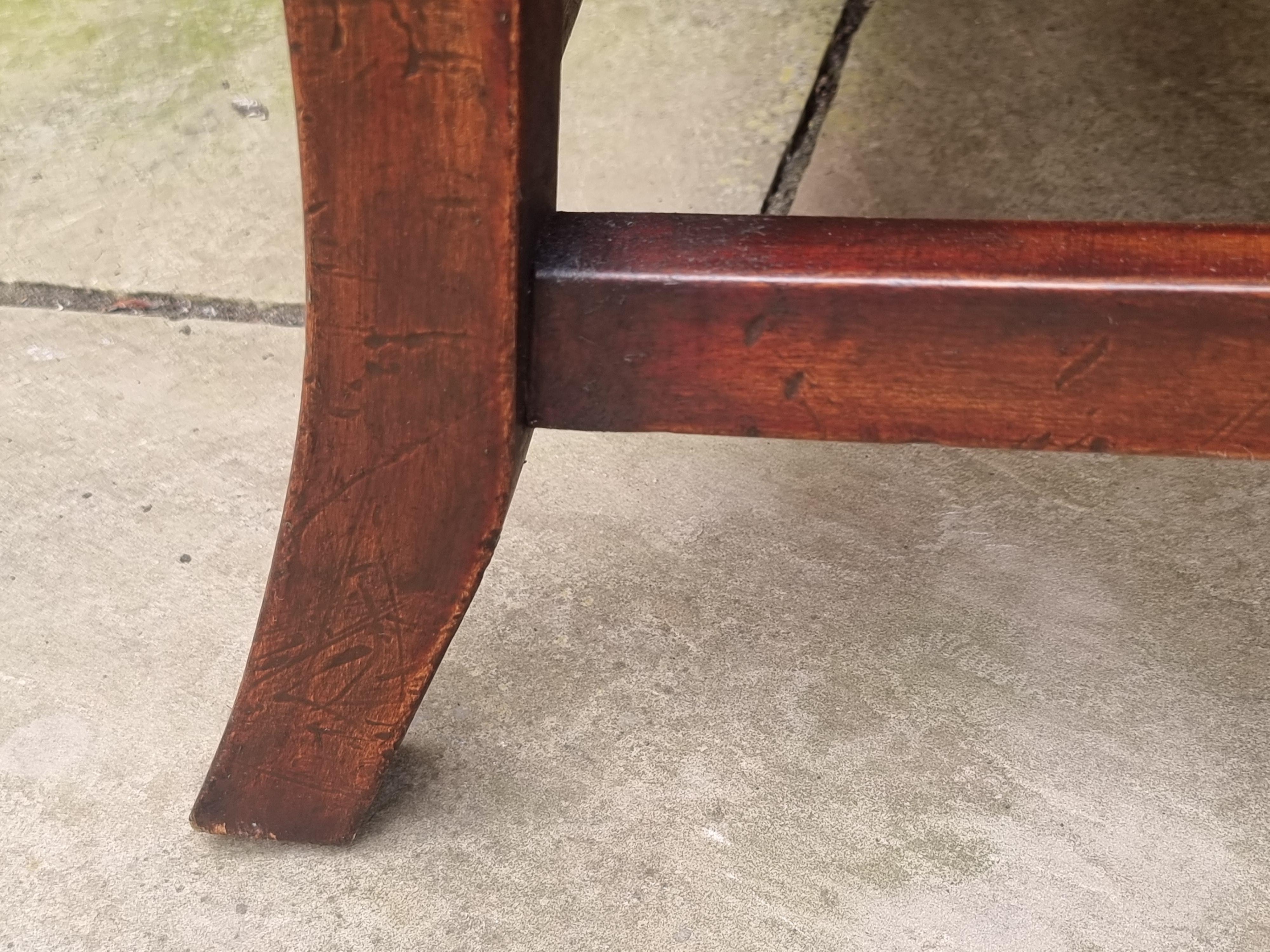 Hand-Crafted Winged armchair upholstered in deep buttoned red leather, English 1930 For Sale