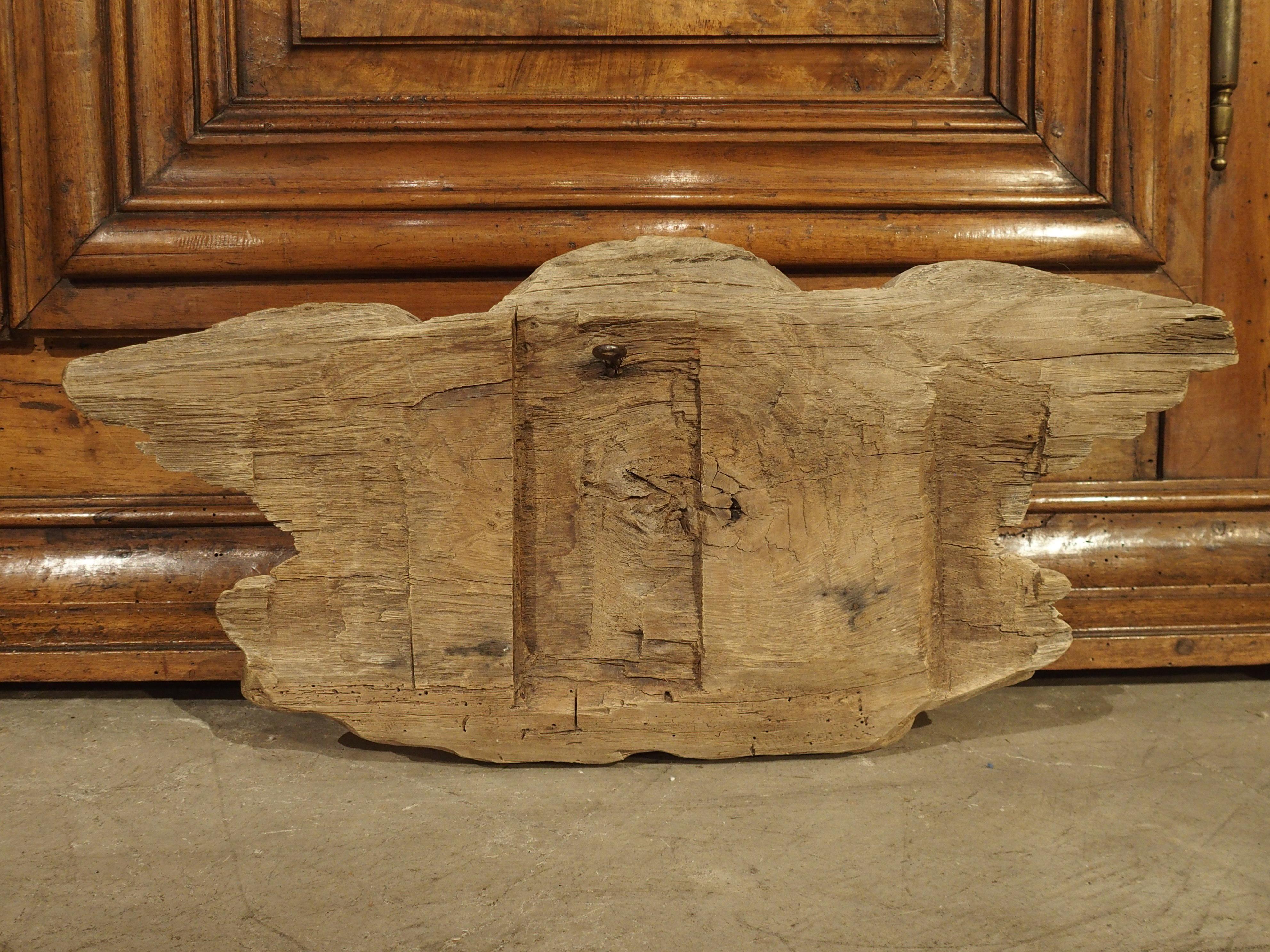 This detailed winged cherub face is surrounded by stylized foliate wings. Hand carved in France, circa 1700, the oak wood has been bleached at some point, revealing beautiful wood grain.

Oak was the preferred wood for crafting furniture and