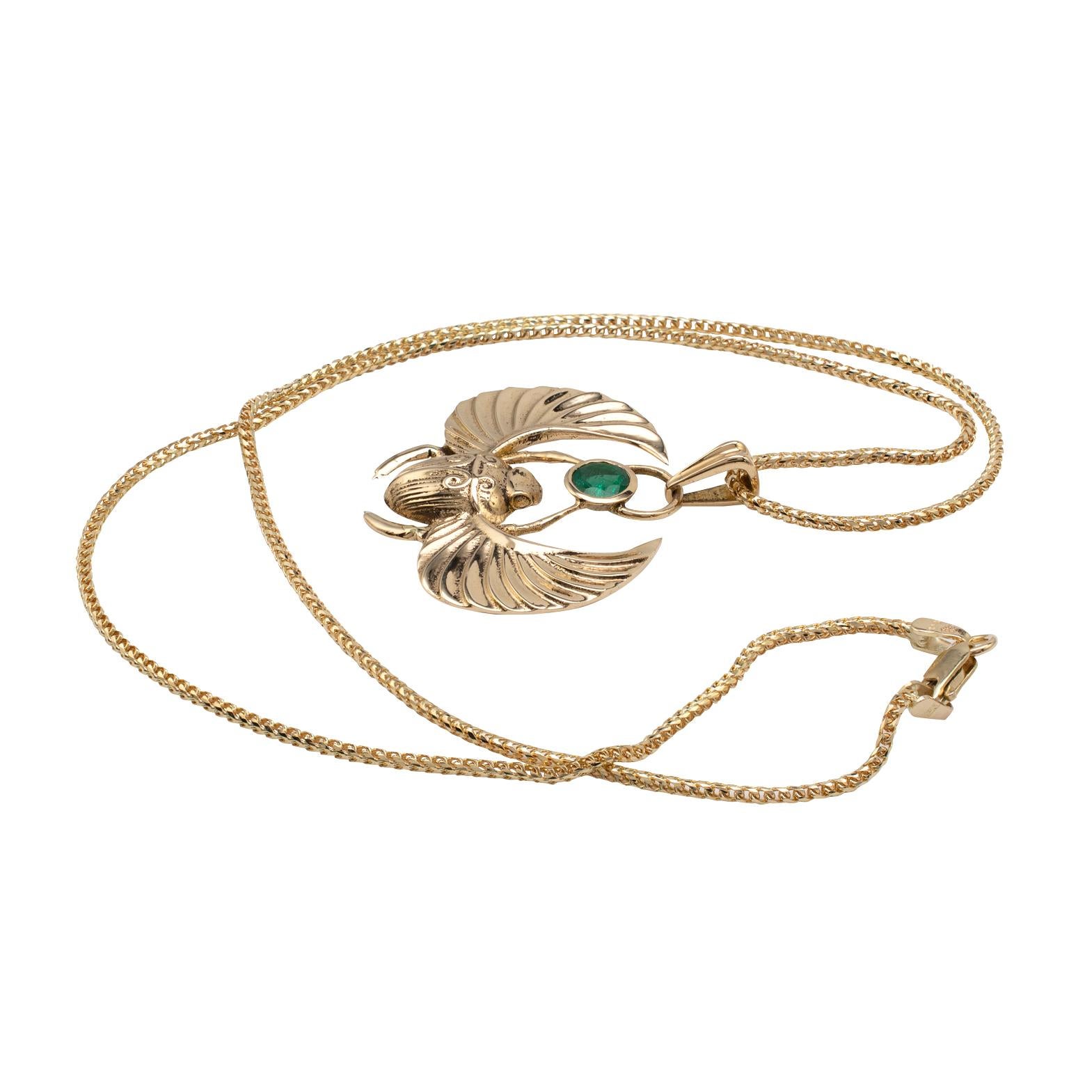 This Egyptian revival Winged Scarab Beetle pendant, fully hallmarked for 14 karat yellow gold, features a beautiful 0.50 carat round cut natural emerald gemstone. 

The custom made his piece displays full UK hallmarks and is expertly modeled with