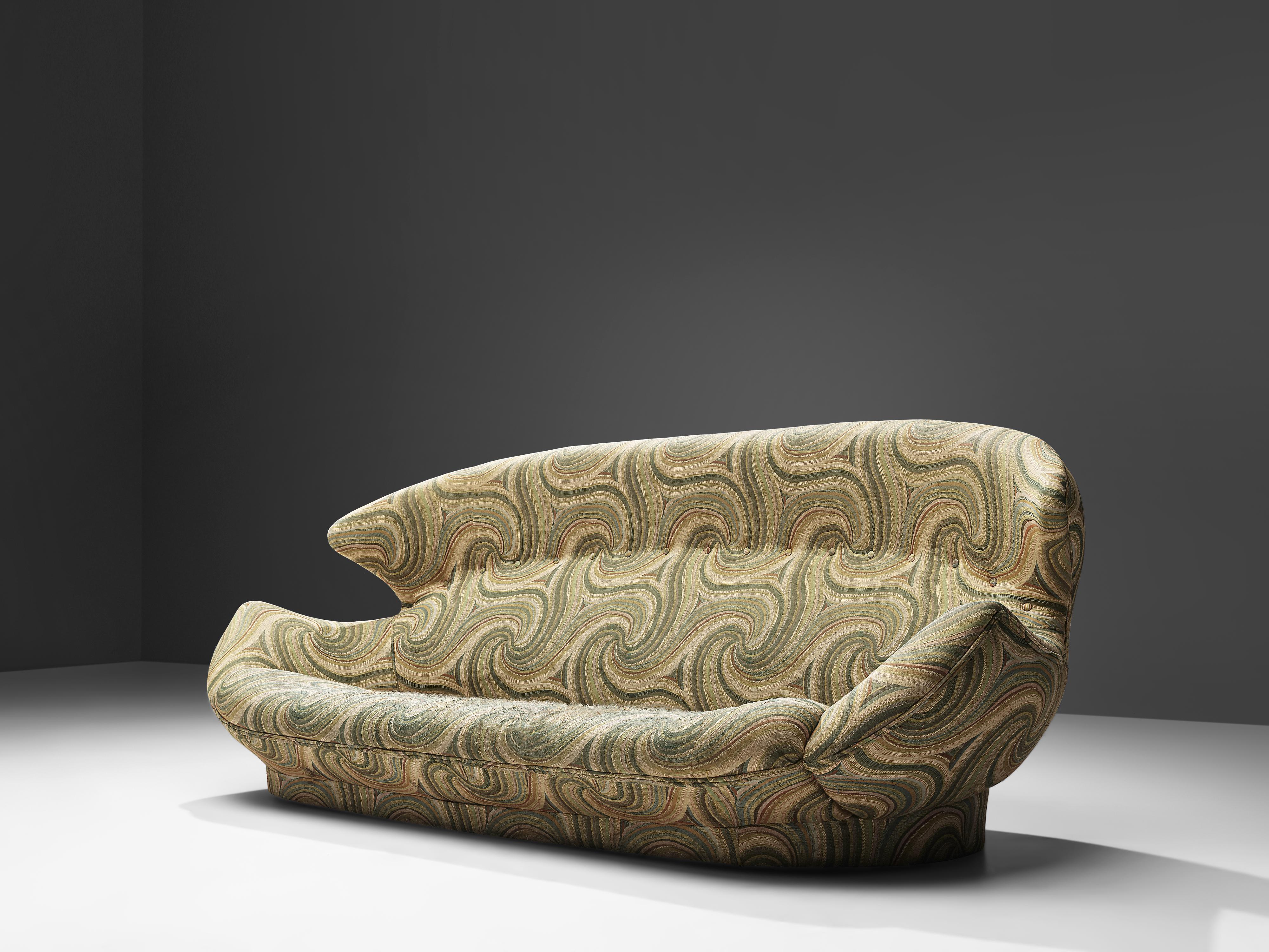 Two-seat sofa, green and cream patterned upholstery, Europe, 1970s

Comfortable winged sofa with hypnotizing and decorative patterned upholstery. The rounded overall shape of the sofa, with the wings reaching towards the armrests, ensures that the