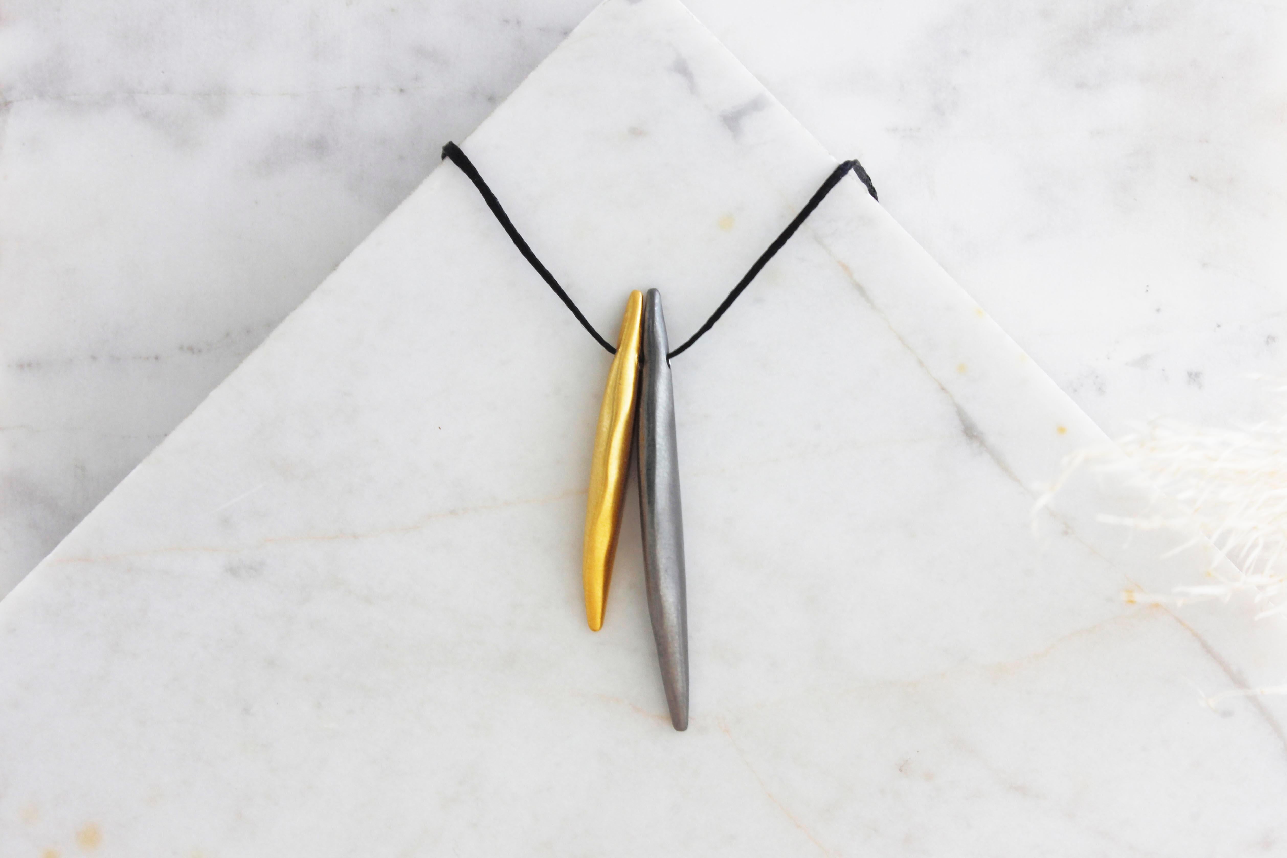 This is an elegant everyday “wings” necklace which consists of two handmade fine silver “wing”. Each “wing” is hammered by hand from a flat sheet into a hollow form, with the edges coming together perfectly above the curve.

The black cord is