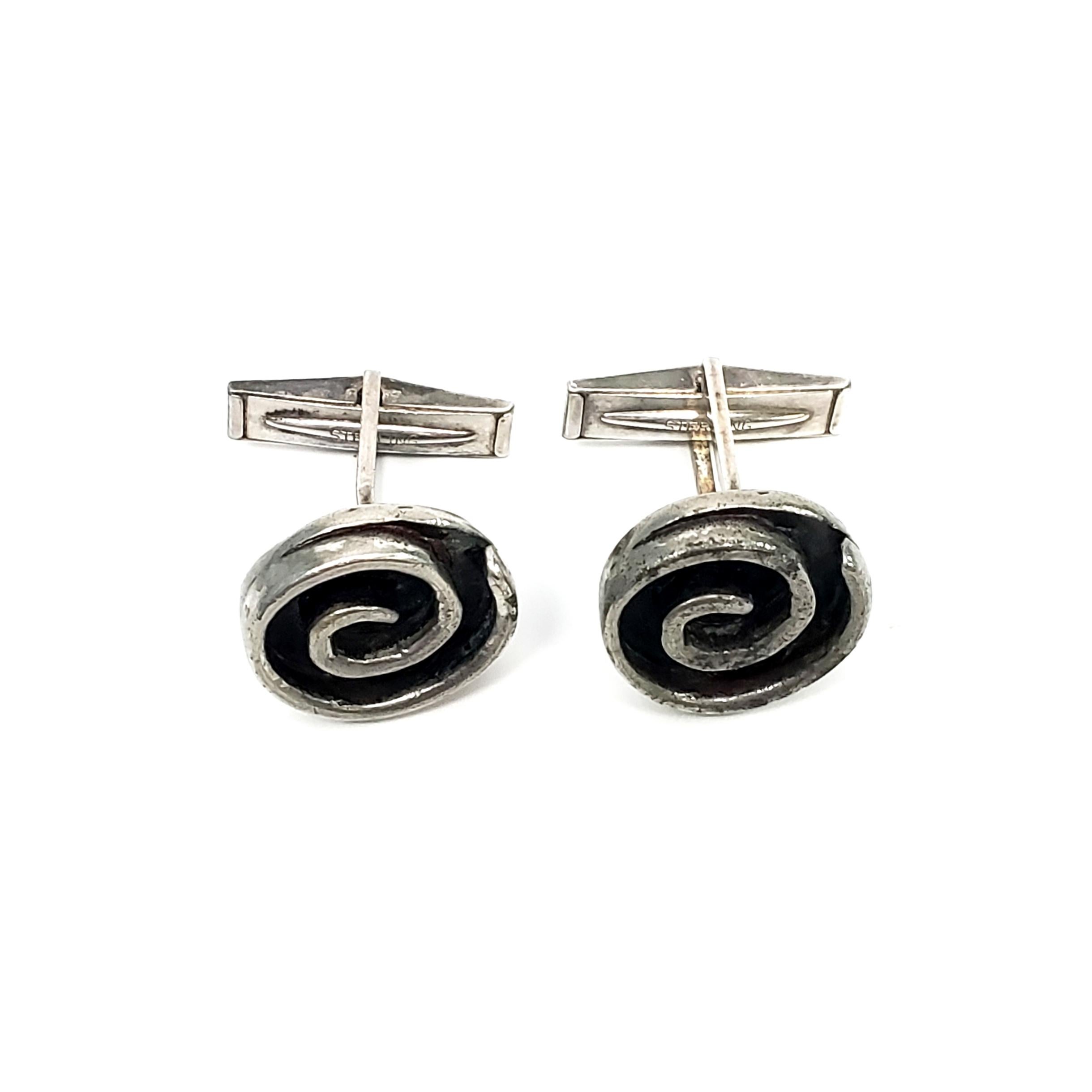Winifred Mason Chenet sterling silver swirl cuff links.

Winifred Mason Chenet was a NYC jewelry designer in the 1940s, making one-of-a-kind pieces for celebrities such as Billie Holiday, and high end retailers.  These cuff links feature an oxidized