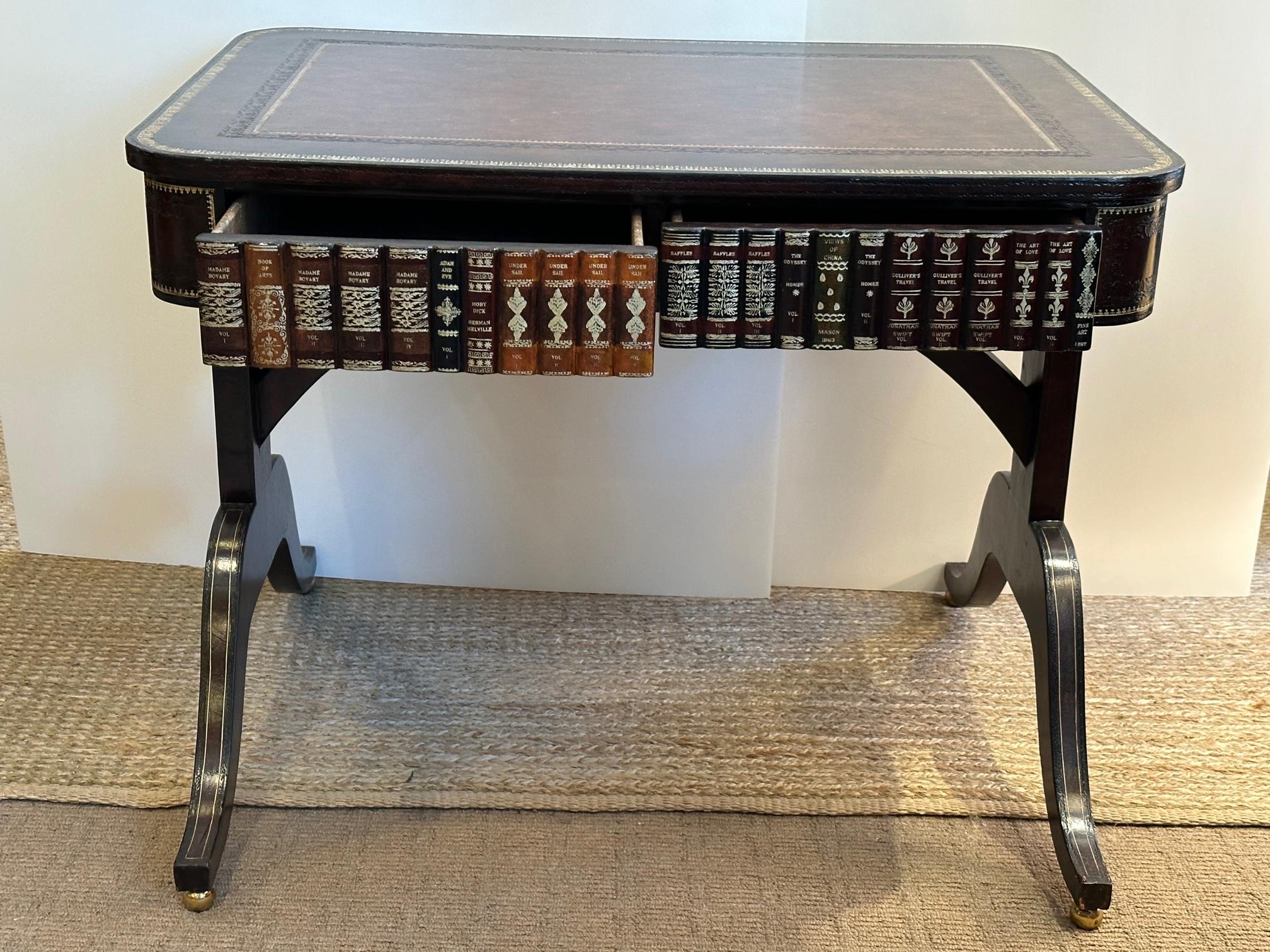 Handsome Maitland Smith leather wrapped writing desk having trompe l'oeil book decoration with two drawers. Top has embossed and gilded leather. 
Opening for chair 23.5.