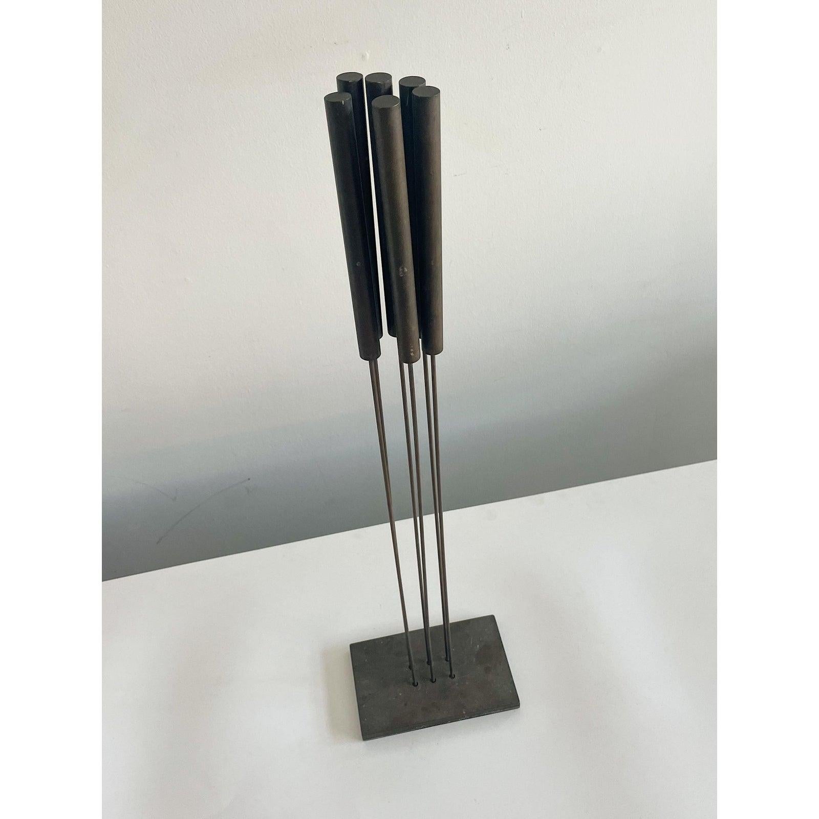 A bronze sonambient floor sculpture done in the style of Harry Bertoia with interactive rods that make a deep resounding chiming sound. signed on base W B 96

Born in Germany, Brueggemann earned degrees in mechanical applied physics and