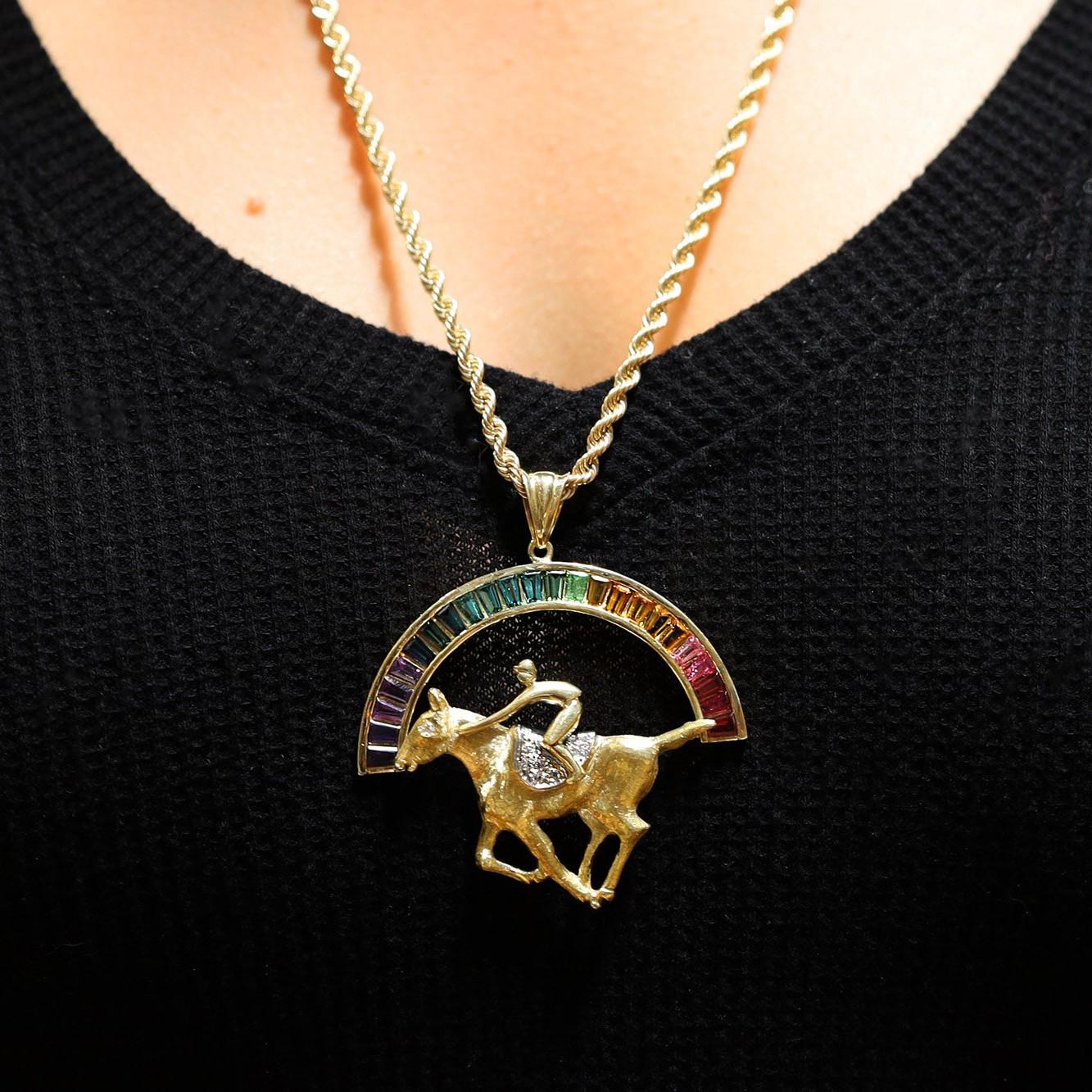 A fabulous thoroughbred horse racing necklace with a story. One of only 3 fillies to win the Kentucky Derby, Winning Colors, with jockey Gary Stevens riding to victory on a pavé diamond saddle below a 4 carat gemstone rainbow of tourmaline, amethyst