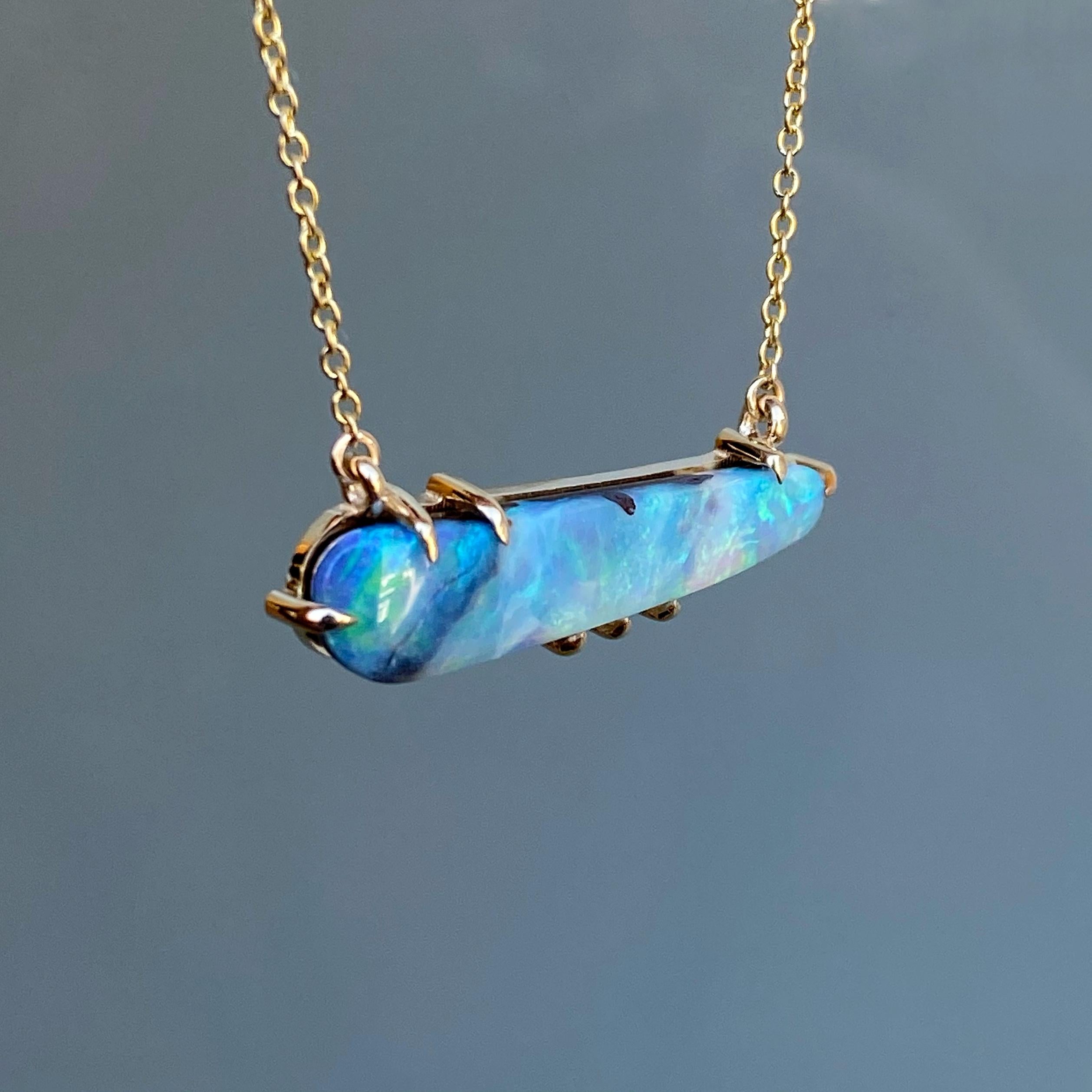 The Winter Flurry Boulder Opal Diamond Station Necklace carefully grips an elongated Boulder Opal...inside of which exists a beautiful winter scene.  This semi-translucent stone oscillates from deep stormy blues to bright turquoise skies, with the