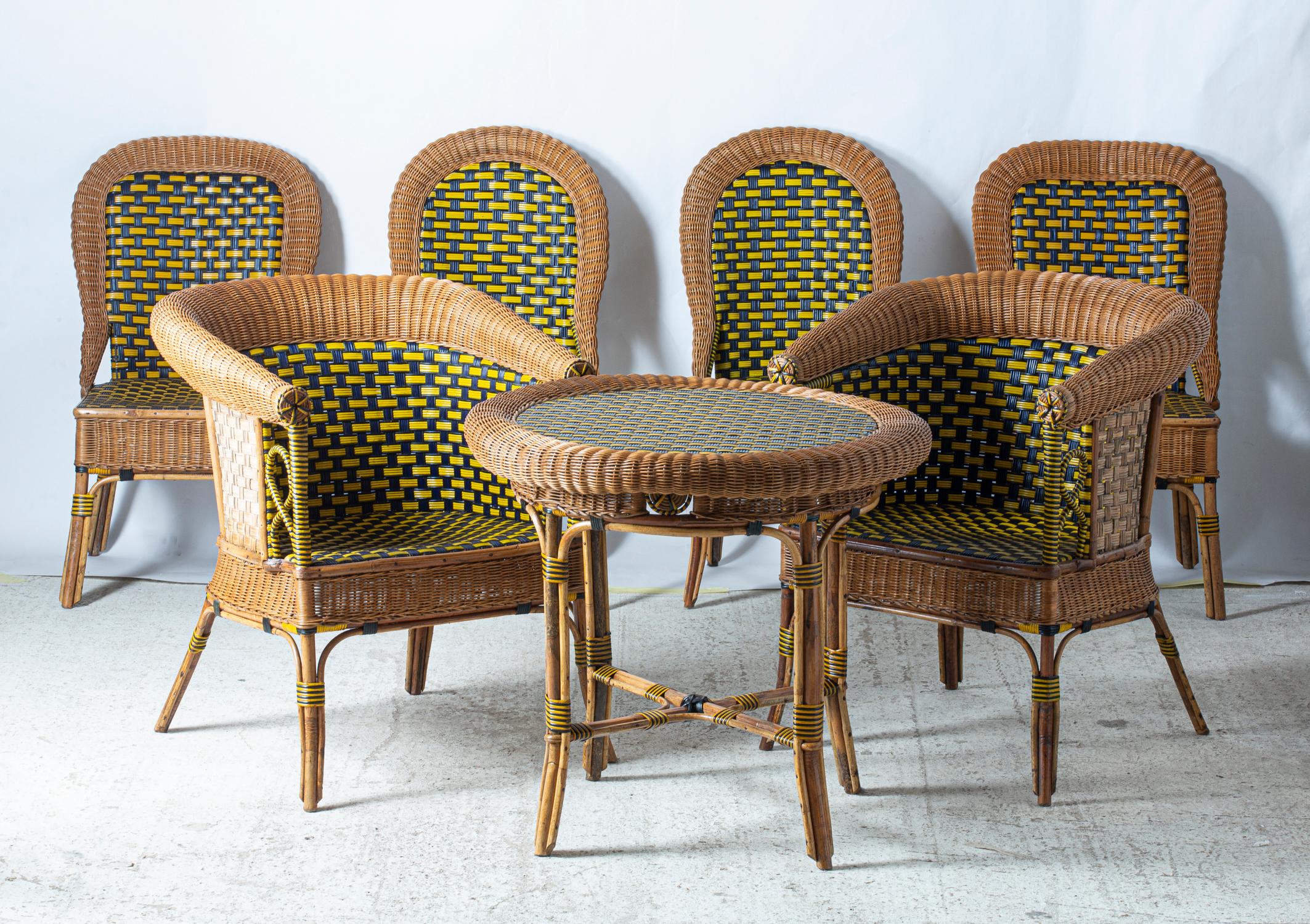 Beautiful set of winter garden furniture consisting of two armchairs, four chairs and a table, made in France in the 1925s. 
Blue and yellow lacquered rattan and natural rattan mixed together in a clever weaving. 
All in excellent