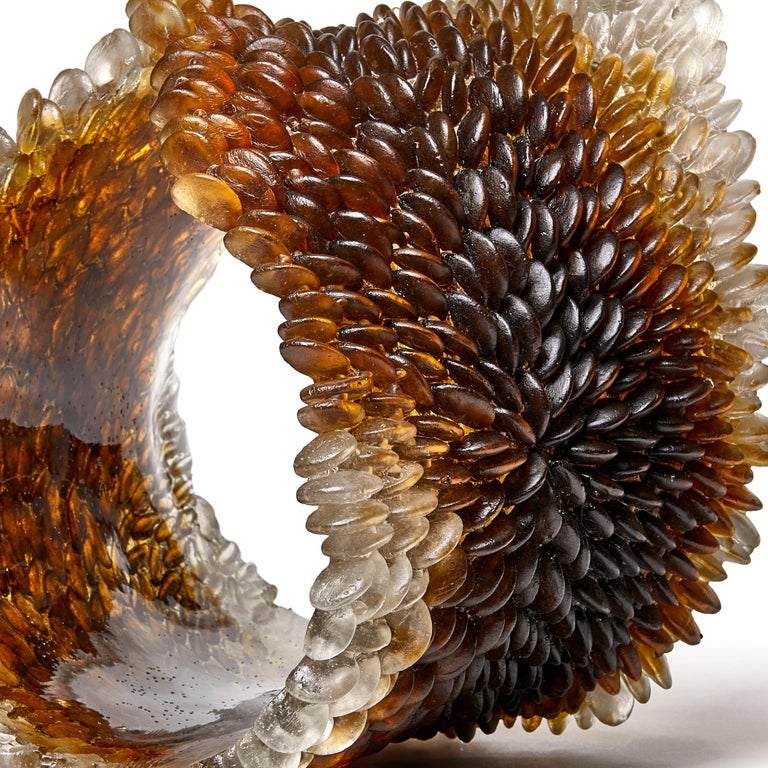 Winter Leaf I is a unique textured glass sculpture in rich brown and amber by the British artist Nina Casson McGarva. 

Casson McGarva firstly casts her glass in a flat mould where she introduces all of the beautifully detailed, scaled surface