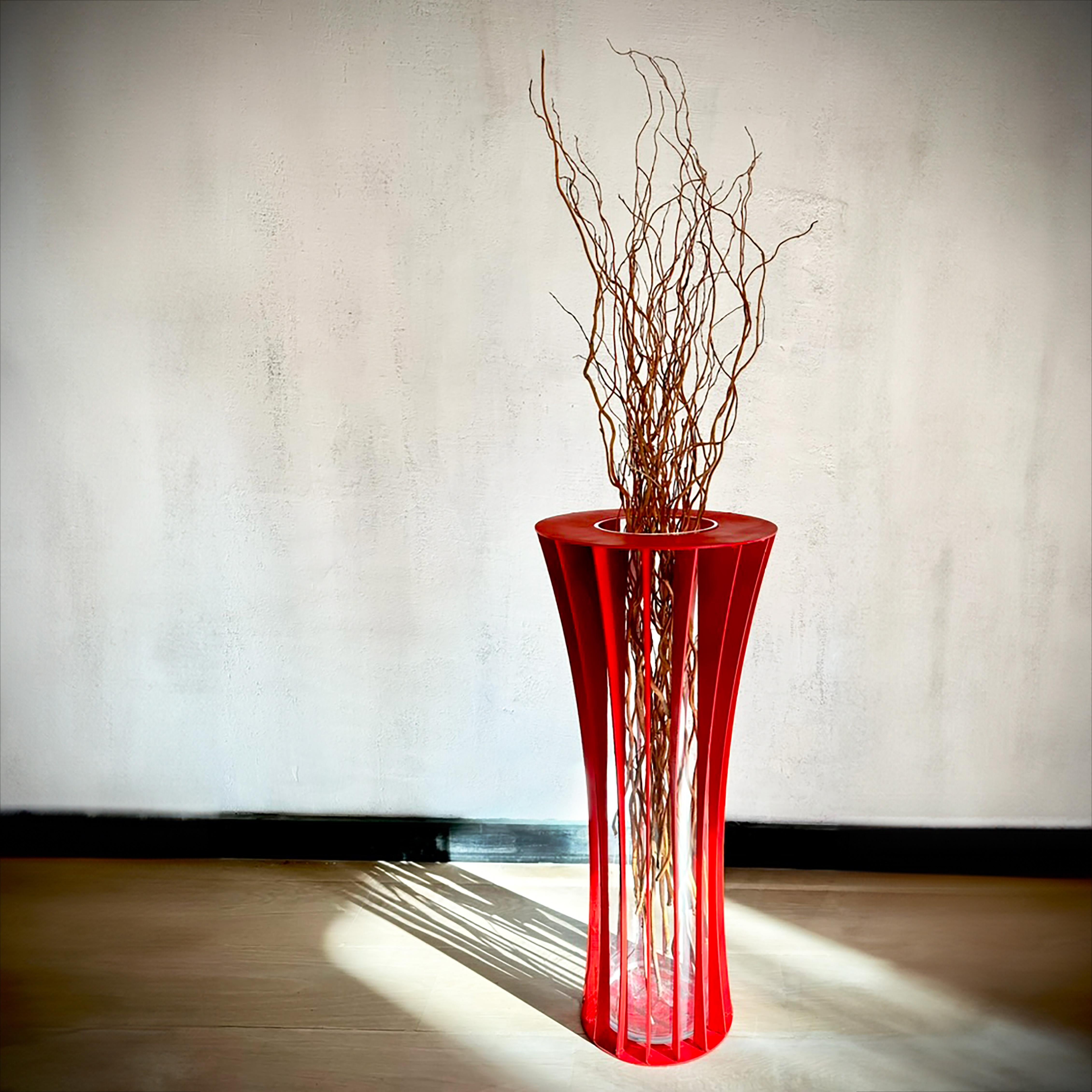 Expertly crafted from steel and glass, the Winzacht Vase is an elegant and colorful post-modern addition to any space. The steel frame creates a stunning silhouette while the glass vase sits perfectly within allowing light to pass through leading to
