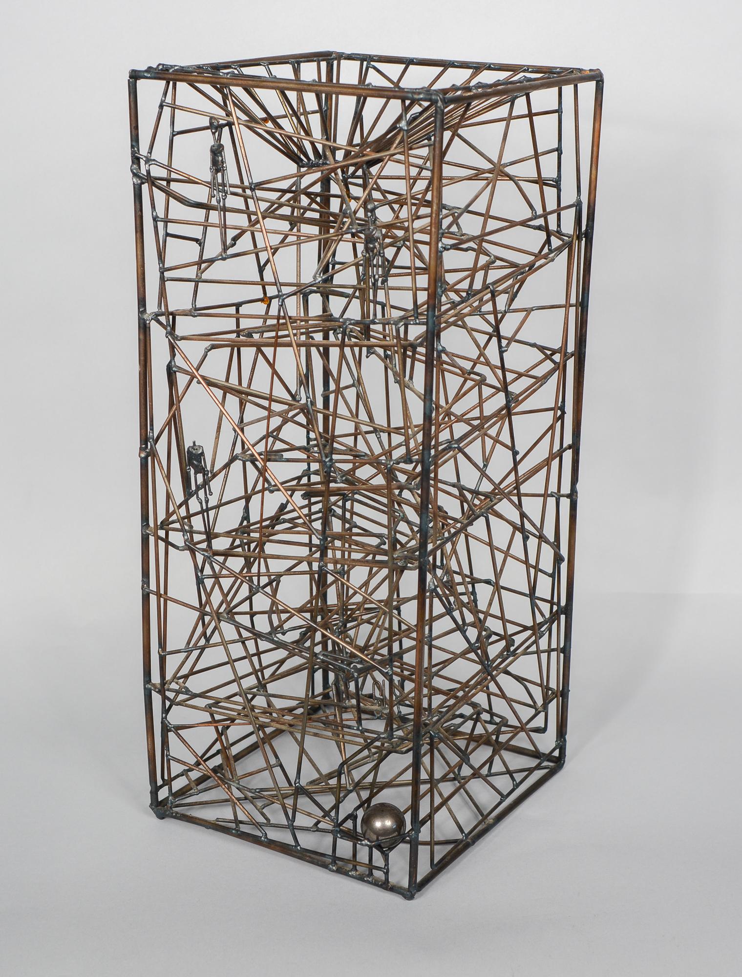 Kinetic wire sculpture by California artist Guy Pullen. Three steel ball bearings are dropped in the top of the tower and they follow a maze like track to the bottom. There are three figures on one side of the sculpture. There is a break to one weld