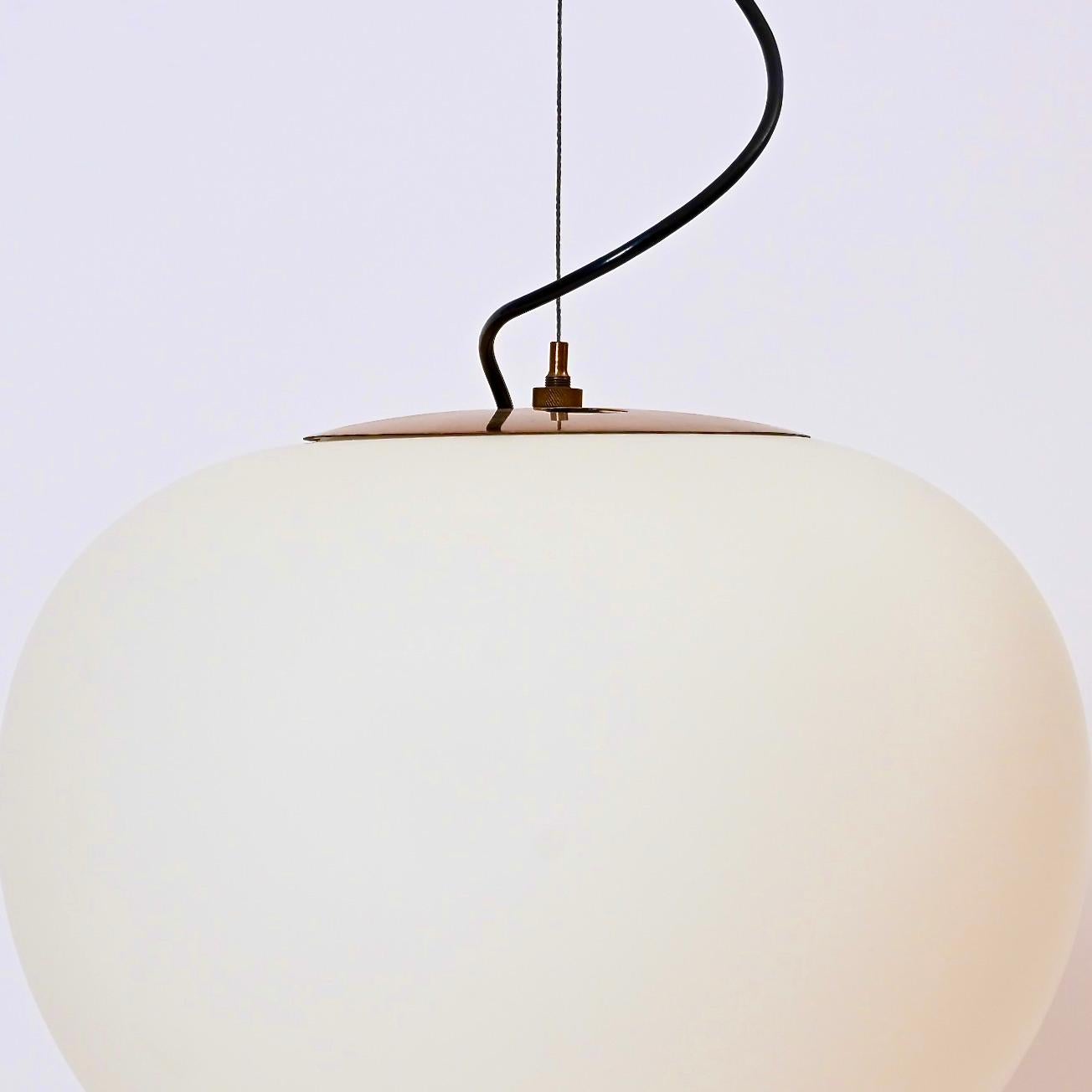 A wire-suspended opaline glass ceiling pendant designed by Bruno Gatta’s innovative Milanese lighting company, Stilnovo. Produced in the 1950s, the light is suspended from a steel wire and comprises of a lacquered brass fitting and a tapered,