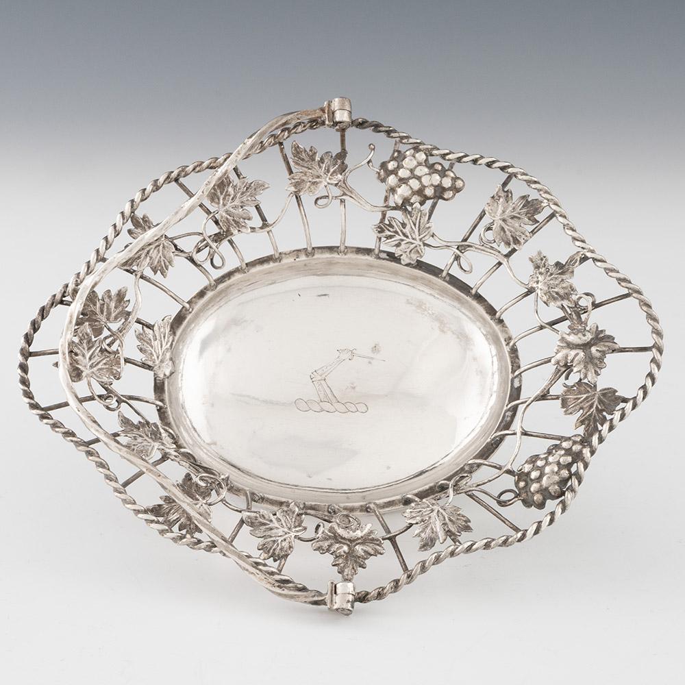 Heading : Pierced silver swing handle basket with fruiting vine decoration
Date : Hallmarked in London in 1766 for William Cripps
Period : George III
Origin : London, England
Decoration : Wire work border with rope twist rim and cast fruiting vine