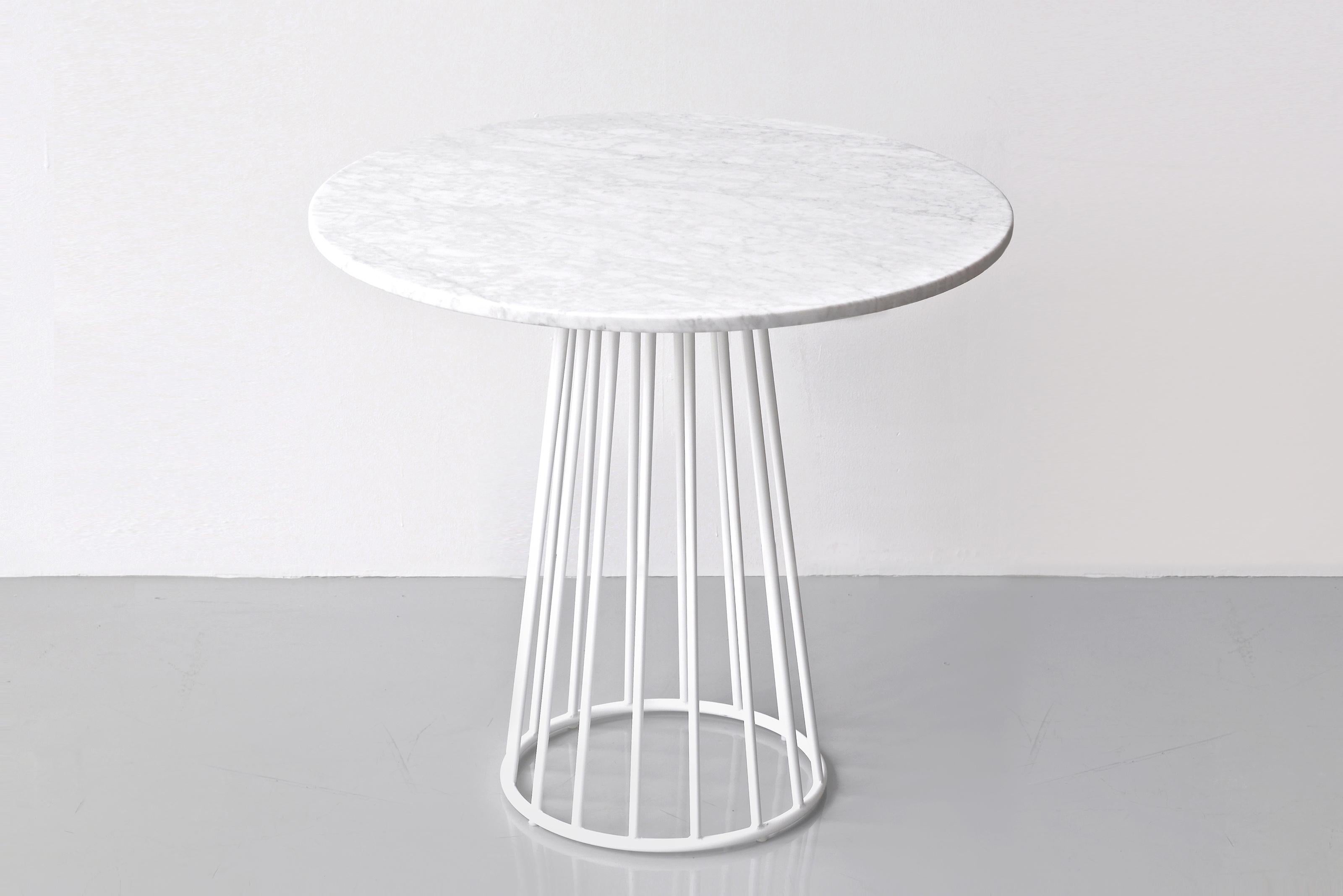Wired Café Table by Phase Design
Dimensions: Ø 101.6 x H 73.7 cm. 
Materials: Powder-coated metal and white Carrara marble.

Solid steel bar with marble or solid wooden tops. Steel bar available in gloss or flat white and black powder coat, polished