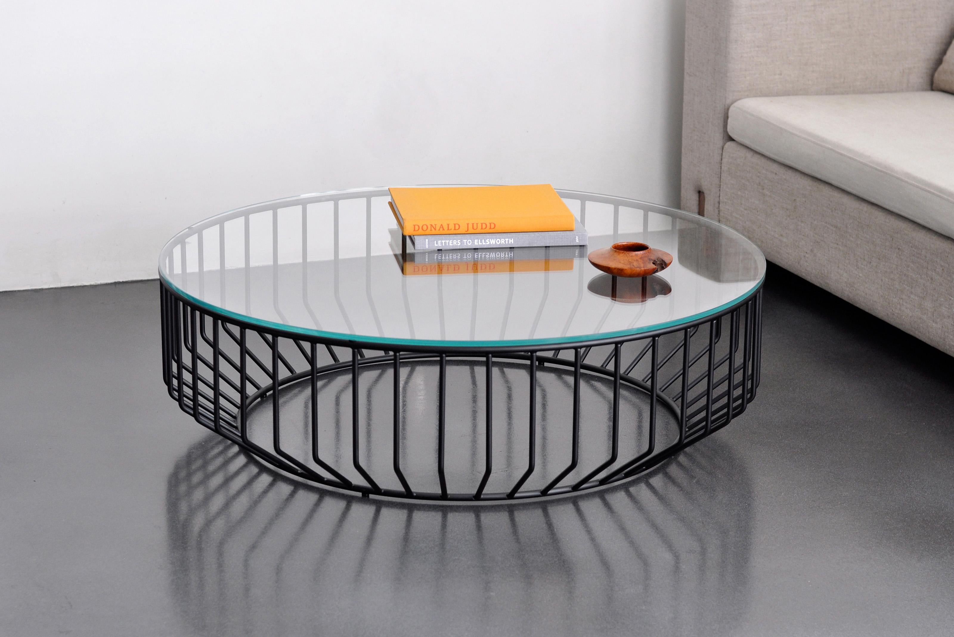 Blending sloping angles and taut lengths of bent metal are a modern interpretation of the wiry idea initially conceived by Warren Platner. The series is made up of a suite of tables, side tables and benches and fitted with luxurious solid wood,