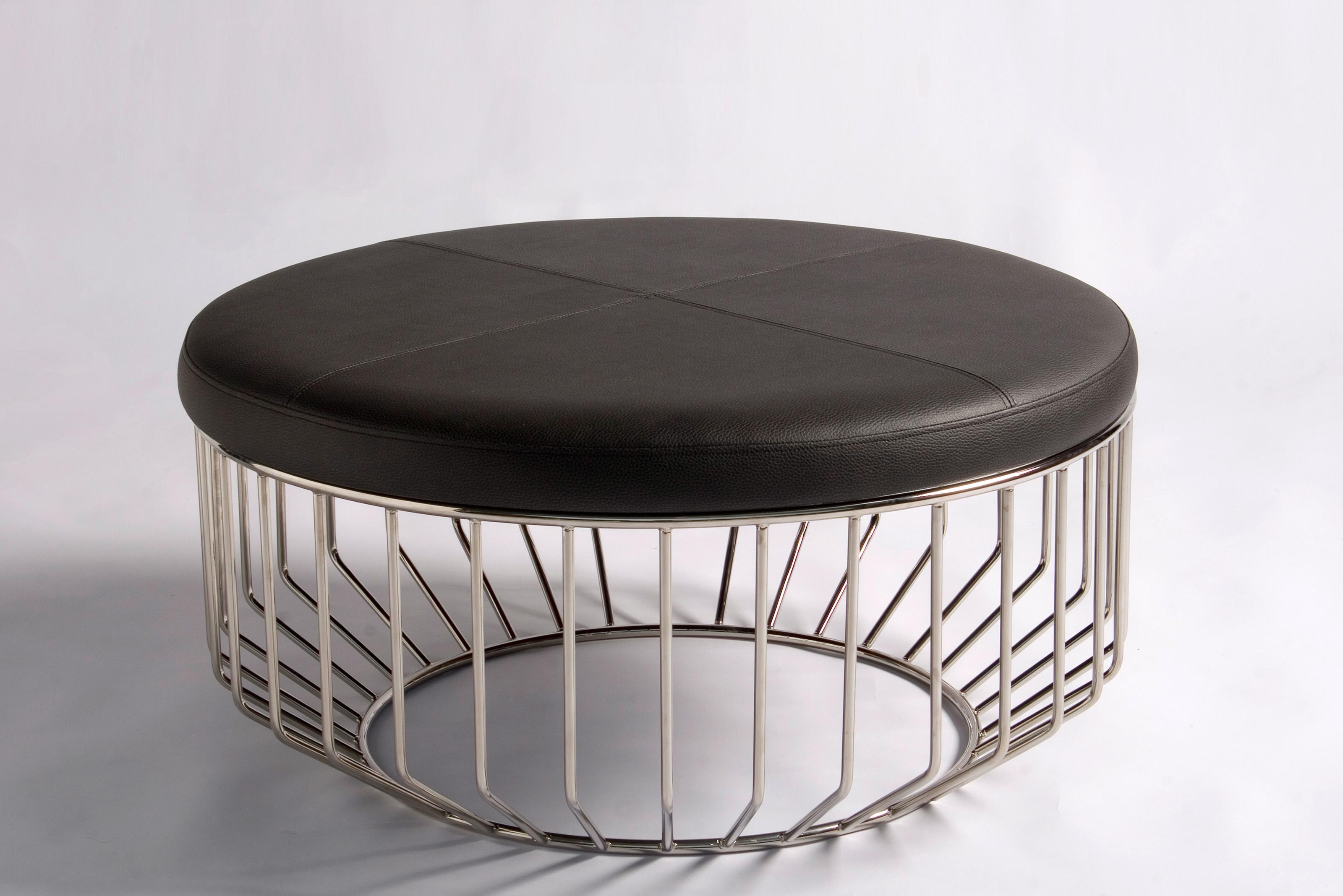 Wired Ottoman by Phase Design
Dimensions: Ø 81.3 x H 38.1  cm. 
Materials: Polished chrome and leather.

Solid steel bar with upholstered tops. Steel available in gloss or flat black and white, polished chrome, burnt copper, or smoked brass finish.