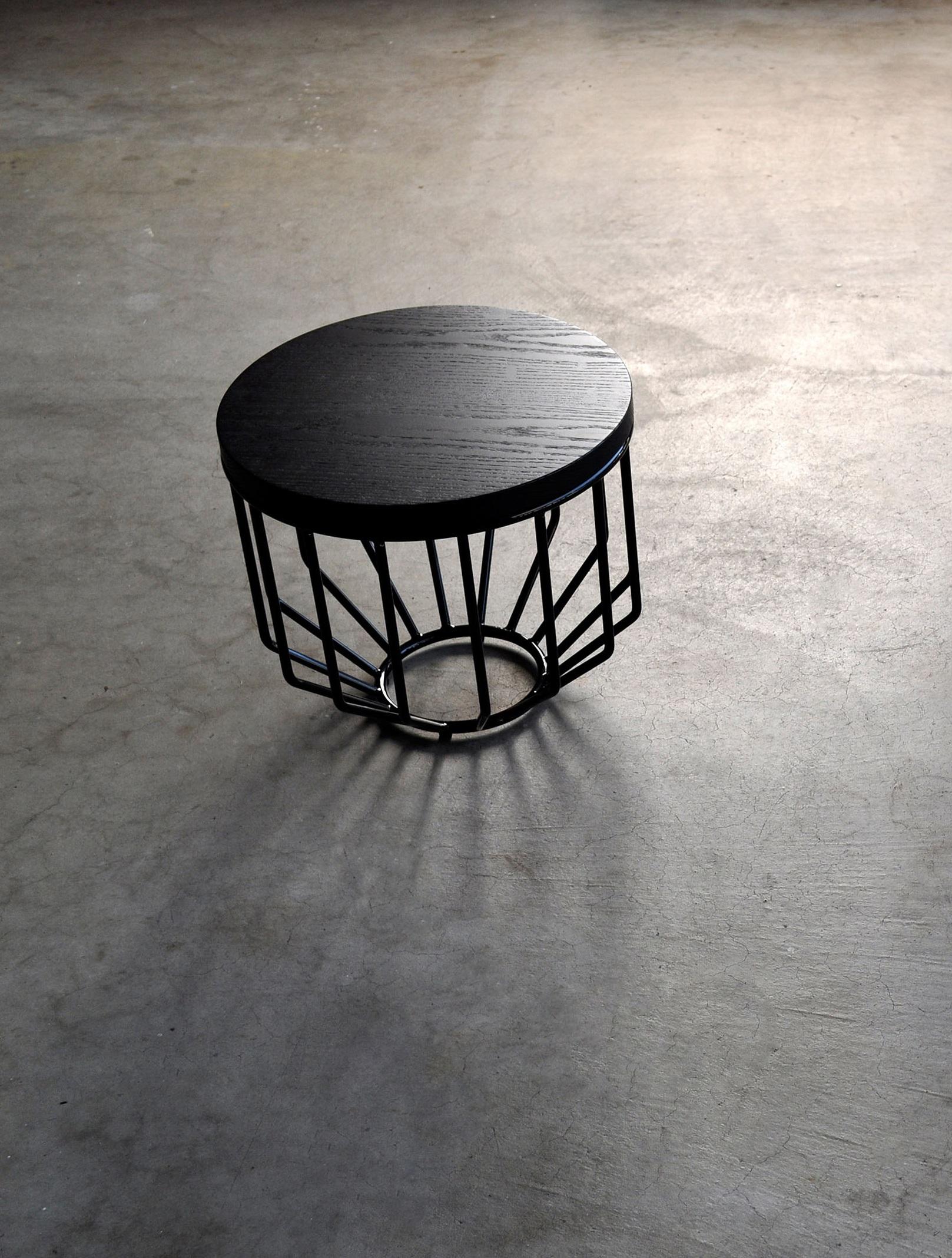 Wired Small Side Table by Phase Design
Dimensions: Ø 38,1 x H 33 cm. 
Materials: Ebonized oak and powder-coated metal. 

Solid steel bar with solid wooden tops, available in walnut, white oak, or ebonized oak. Steel available in gloss or flat black